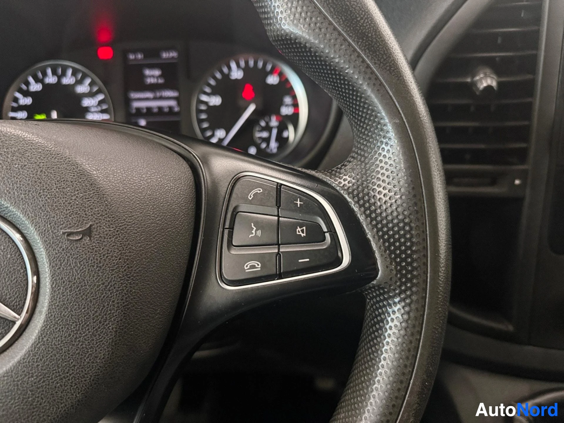 Steering wheel spoke with multifunction control buttons and gauges