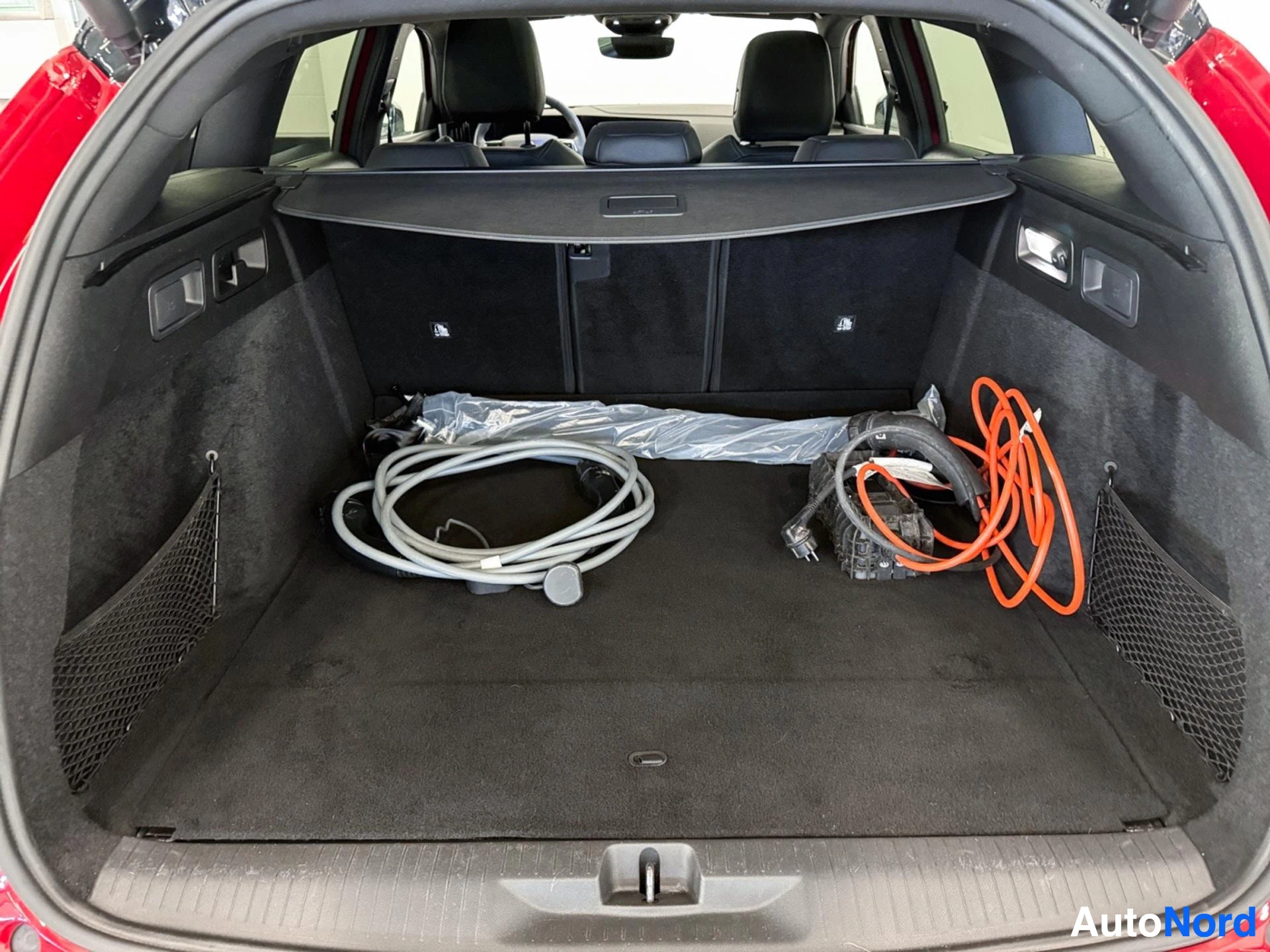 Cargo area with charging cables and equipment stored inside