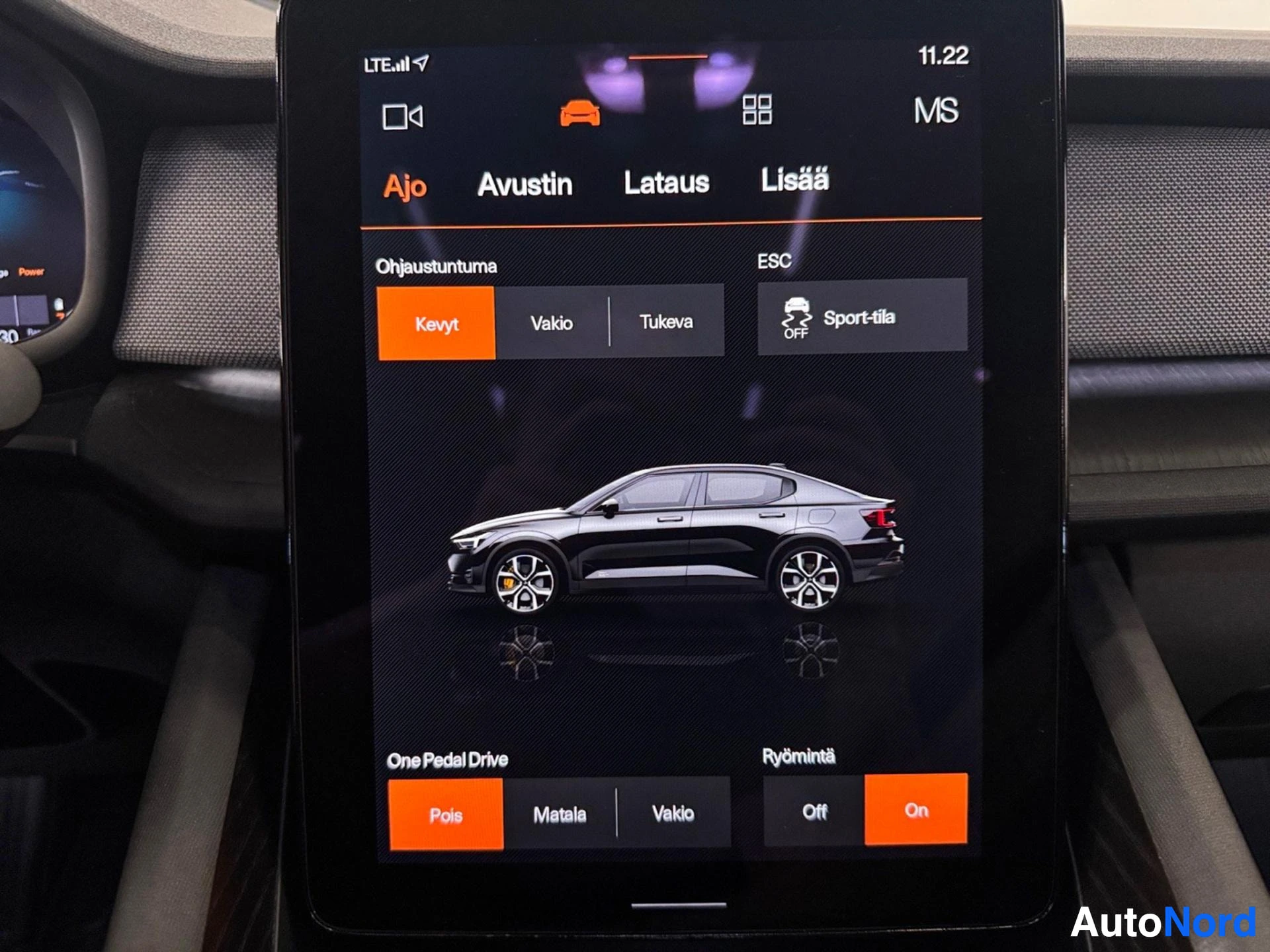 Infotainment screen displaying vehicle settings menu with driving modes and suspension options