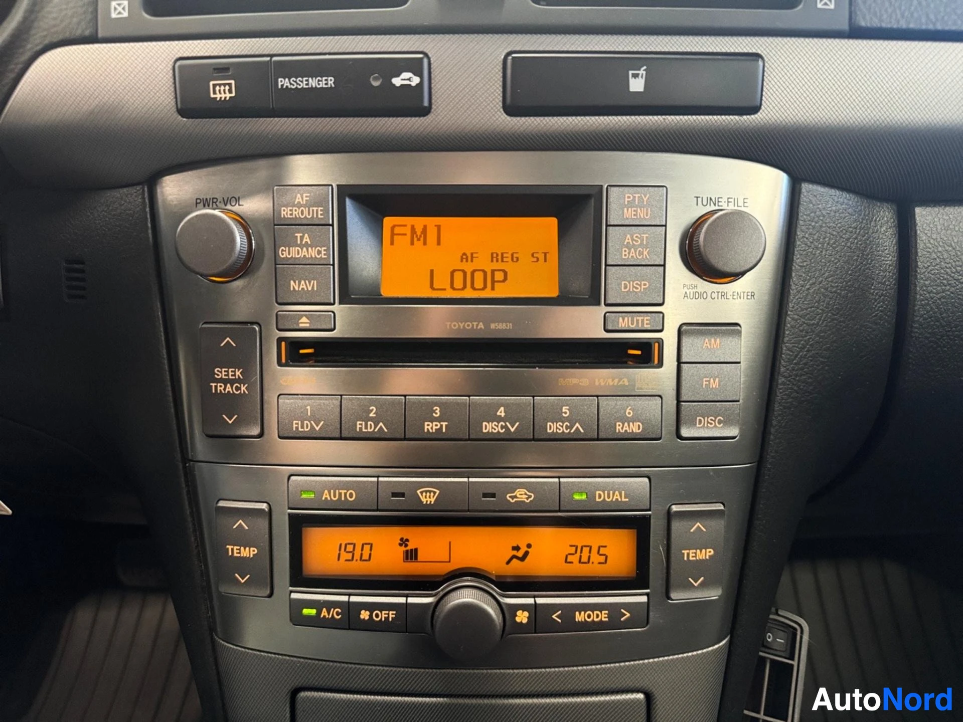 Dashboard center console with FM radio, navigation, climate control, and dual zone climate display