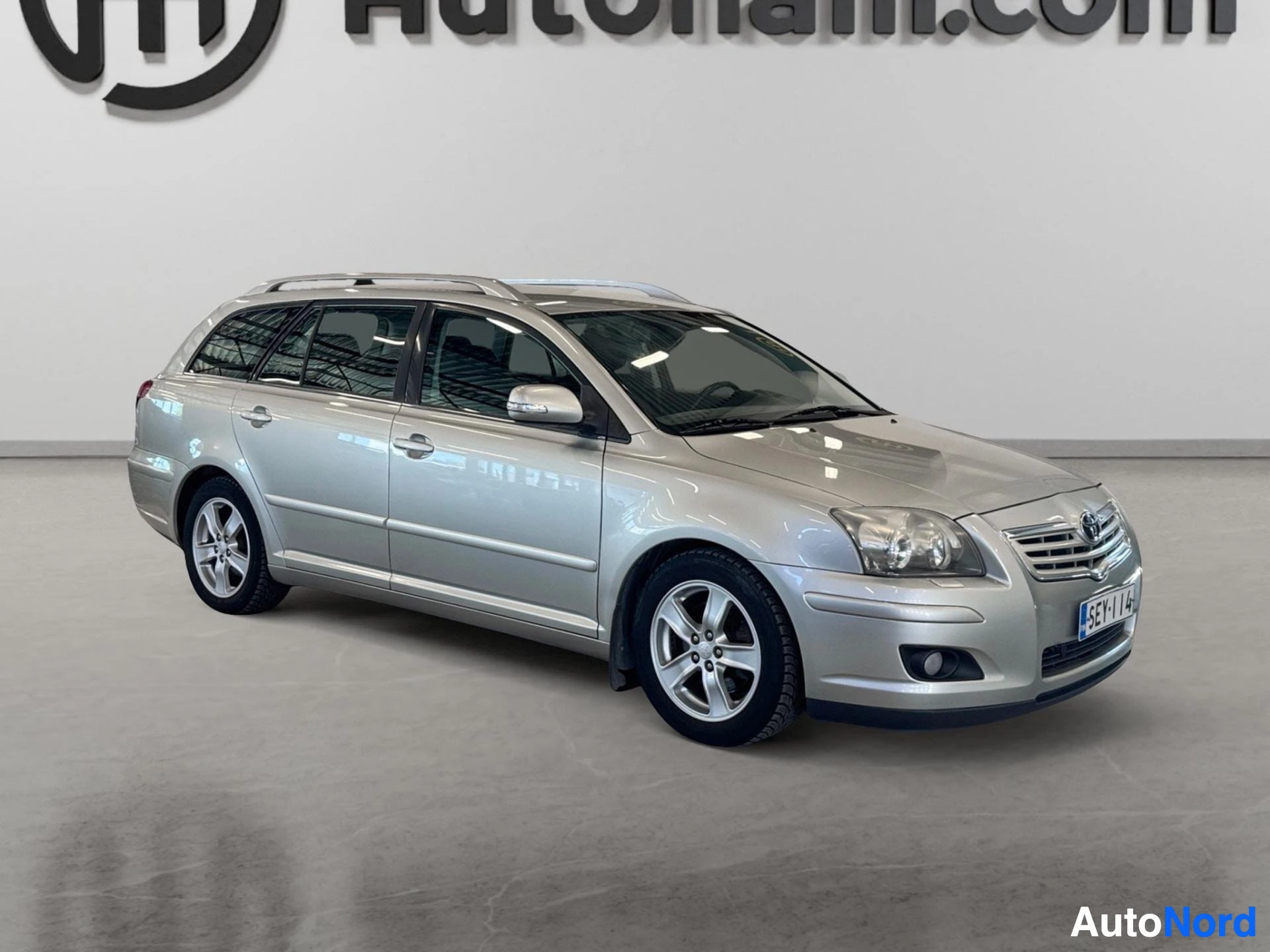 Hopeanvärinen Toyota Avensis farmari, puoli-etupuoli näkymä
