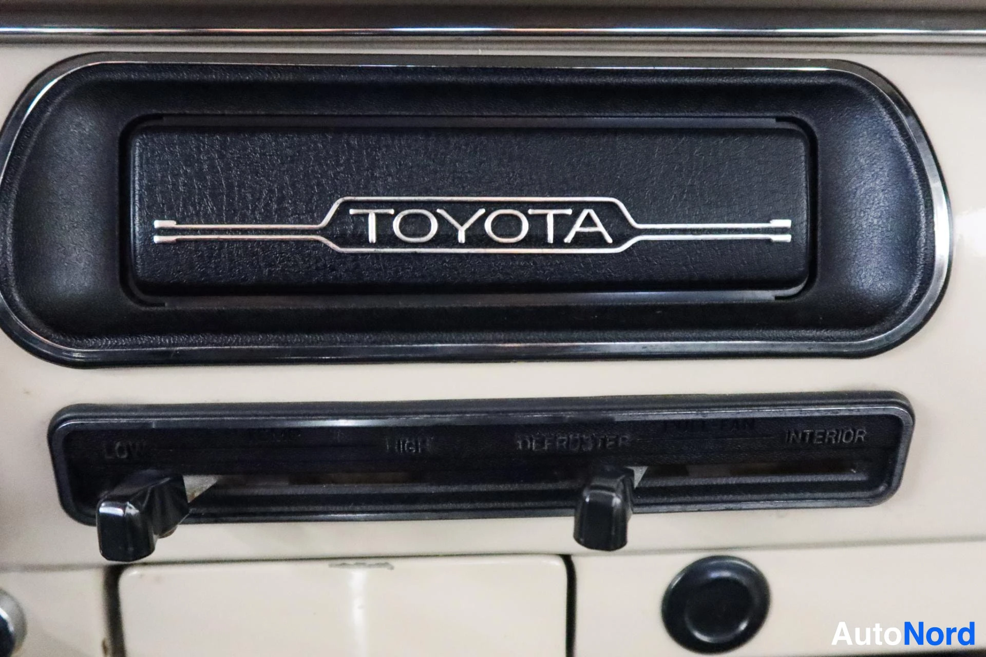 Toyota-merkki mustalla pohjalla ja ilmanvaihdon säätöpalkki sisällä