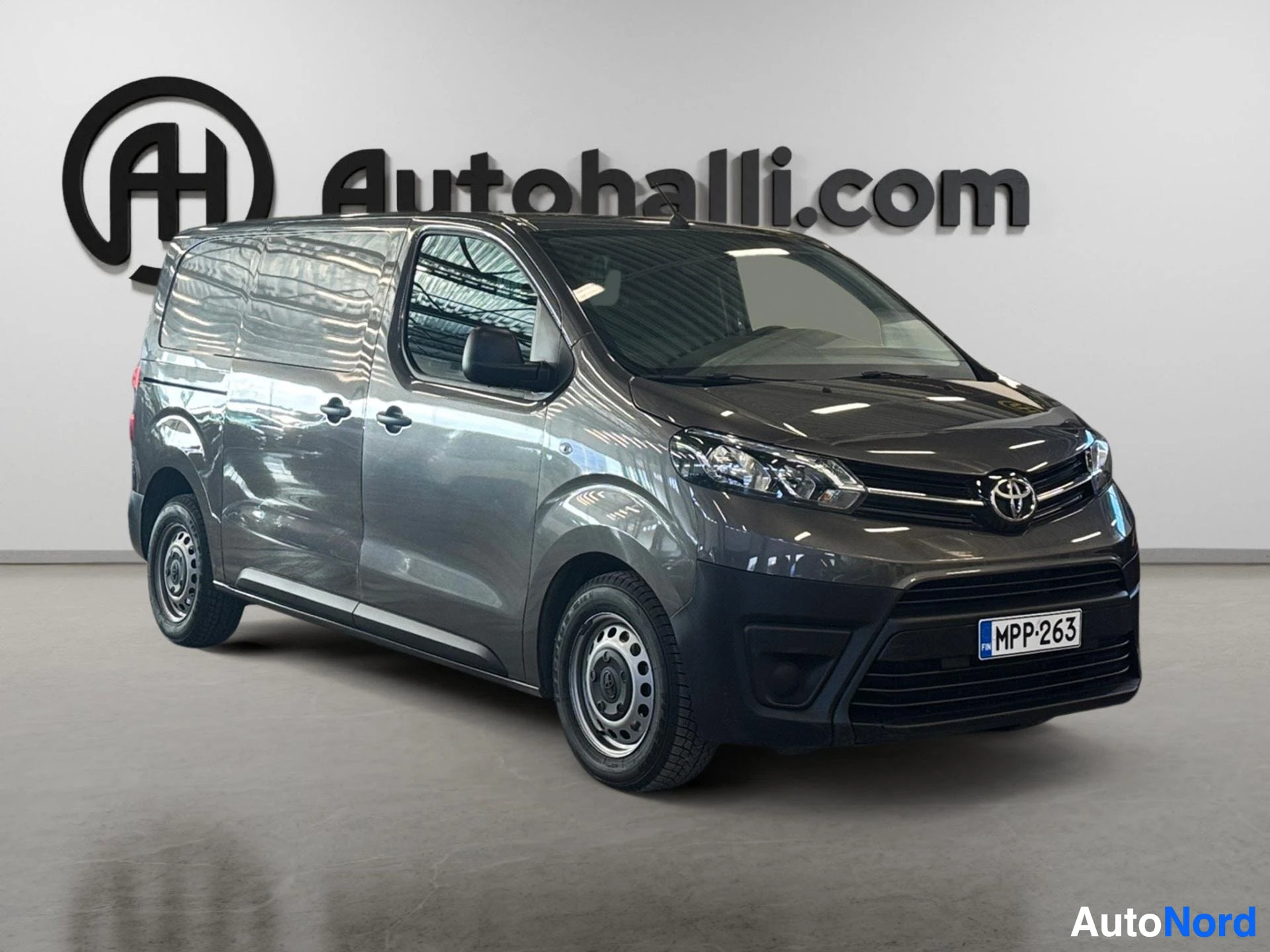 Black Toyota van photographed from front-right angle in studio setting