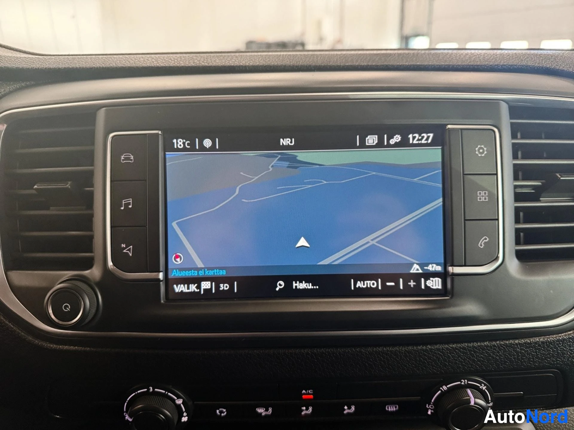 Infotainment system with navigation map display and climate controls visible