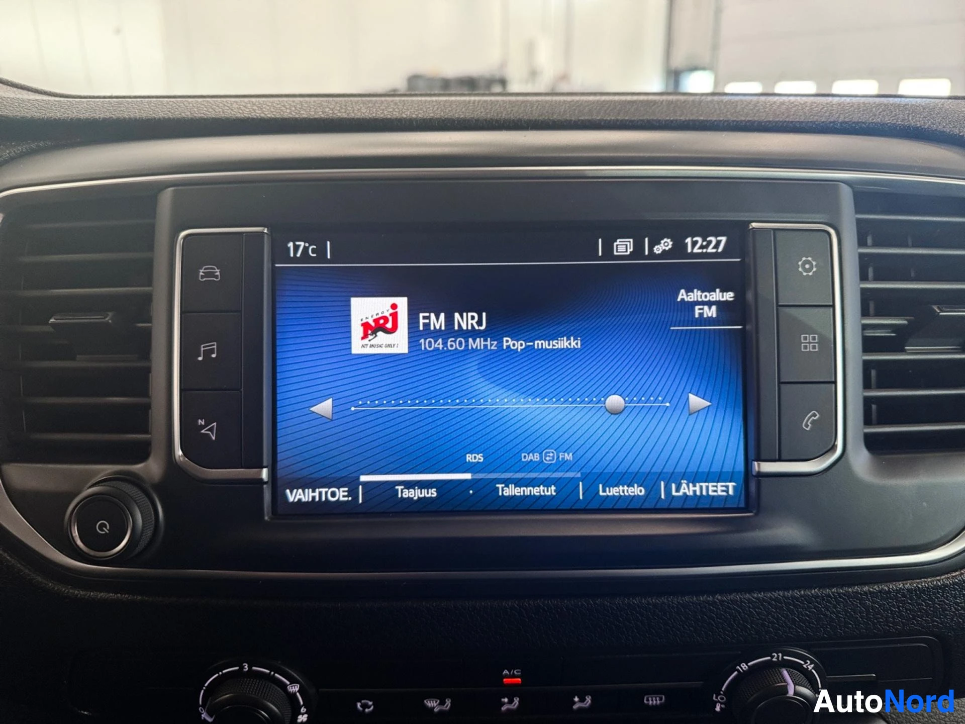 Infotainment system displaying FM radio with NRJ station tuned