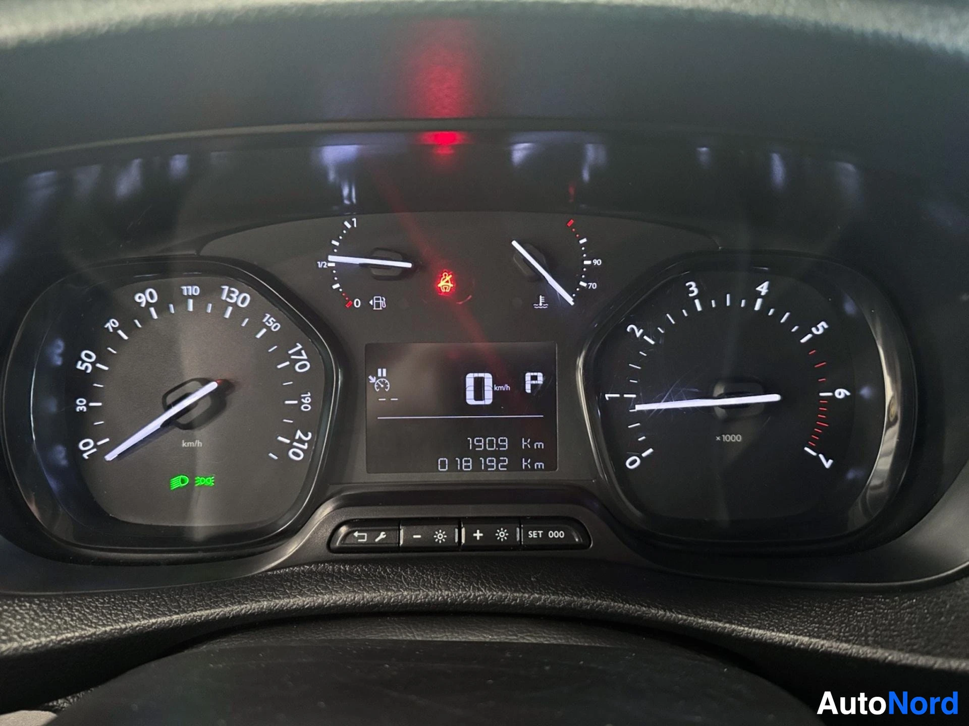 Instrument cluster showing speedometer, fuel gauge, tachometer, and odometer readings