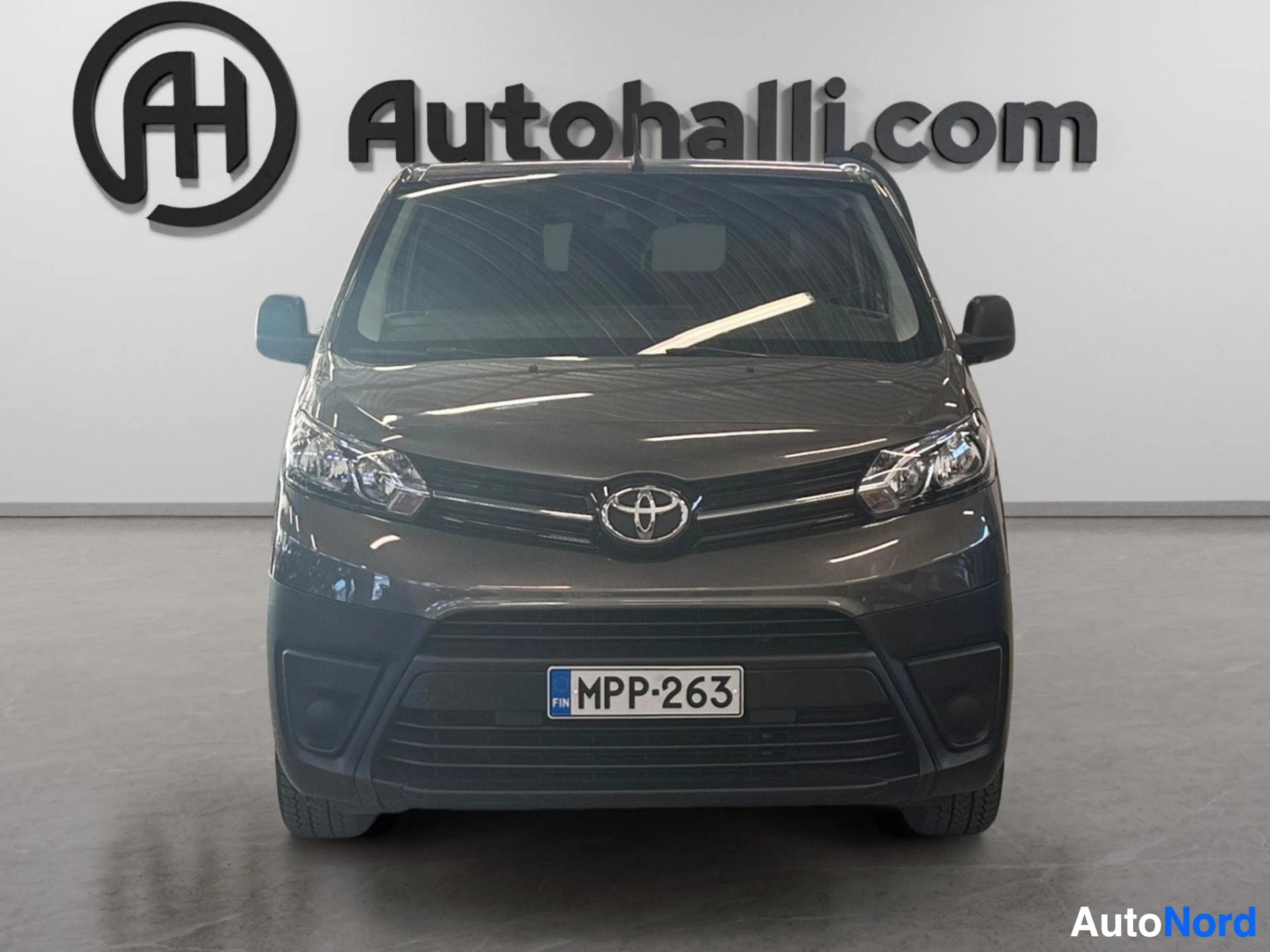 Black Toyota van front view with Toyota grille and headlights visible