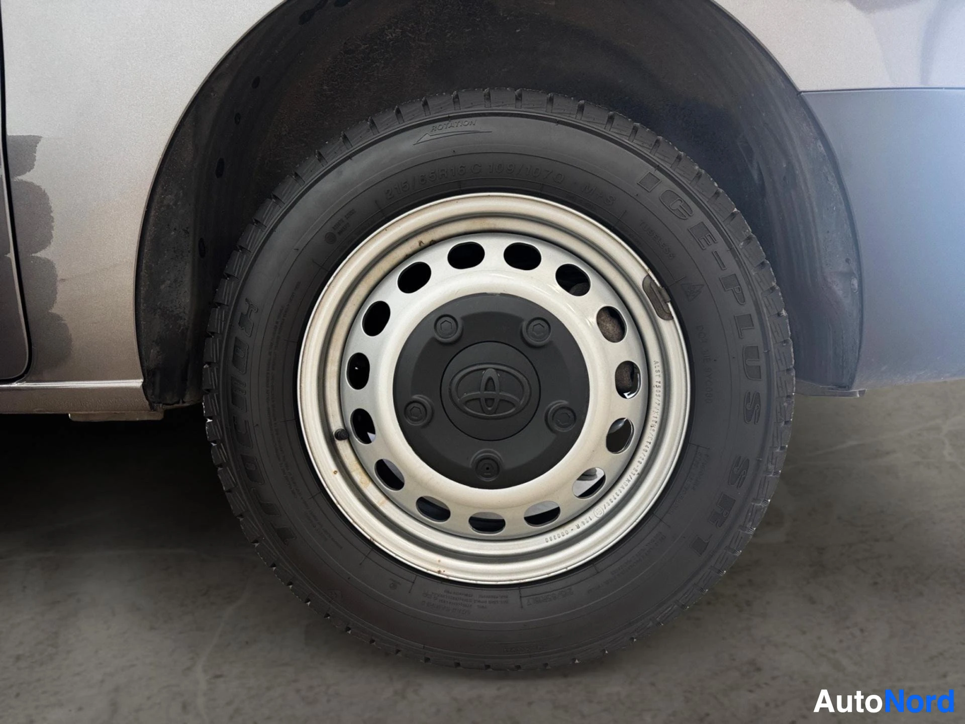 Silver and black alloy wheel with two-tone design and tire