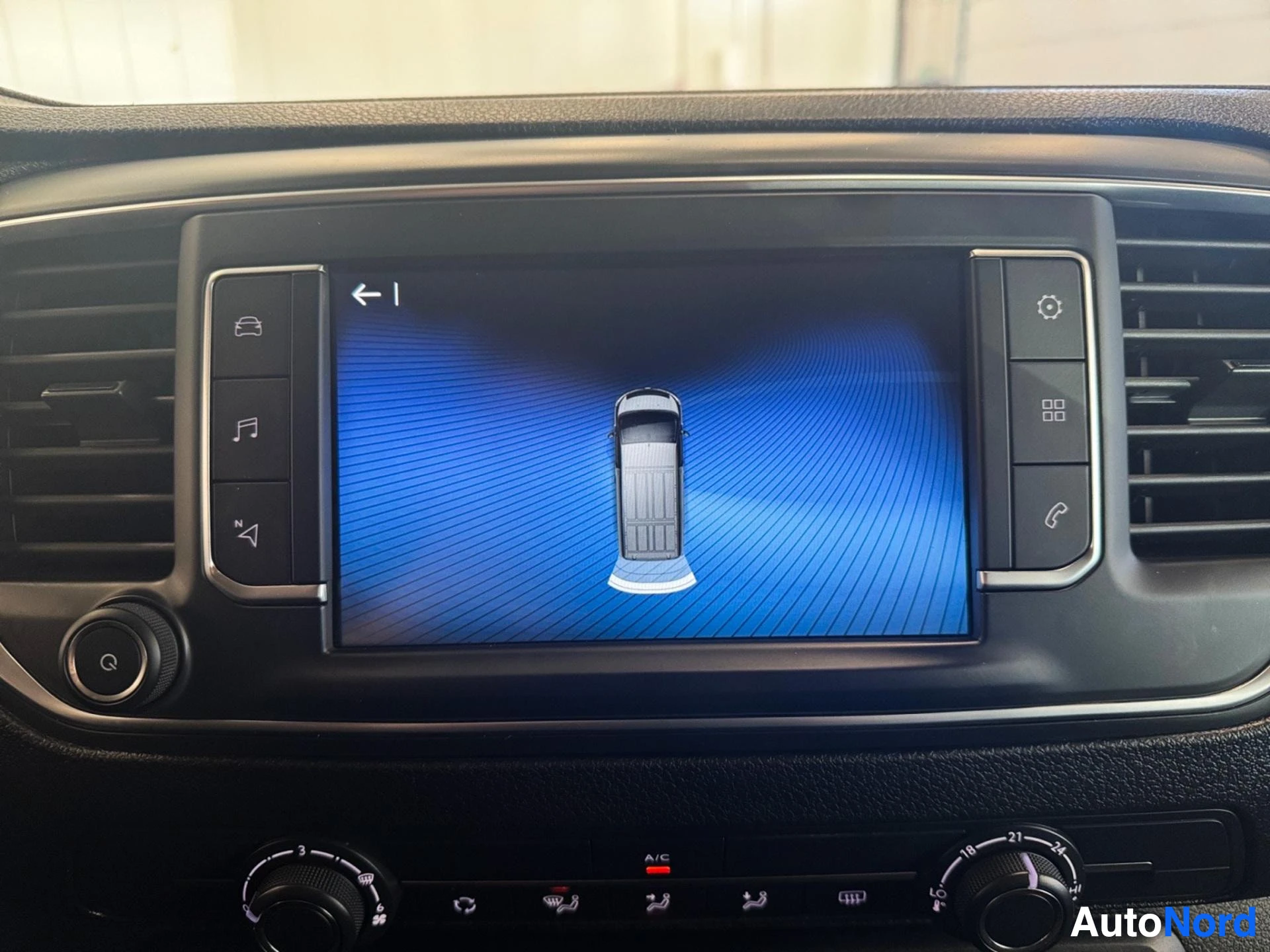 Touchscreen display showing vehicle parking camera and assistance view