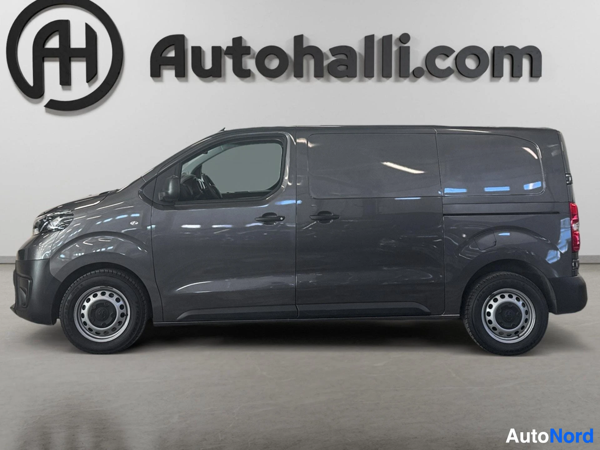 Dark gray Toyota Proace van side profile view with windows and wheels visible