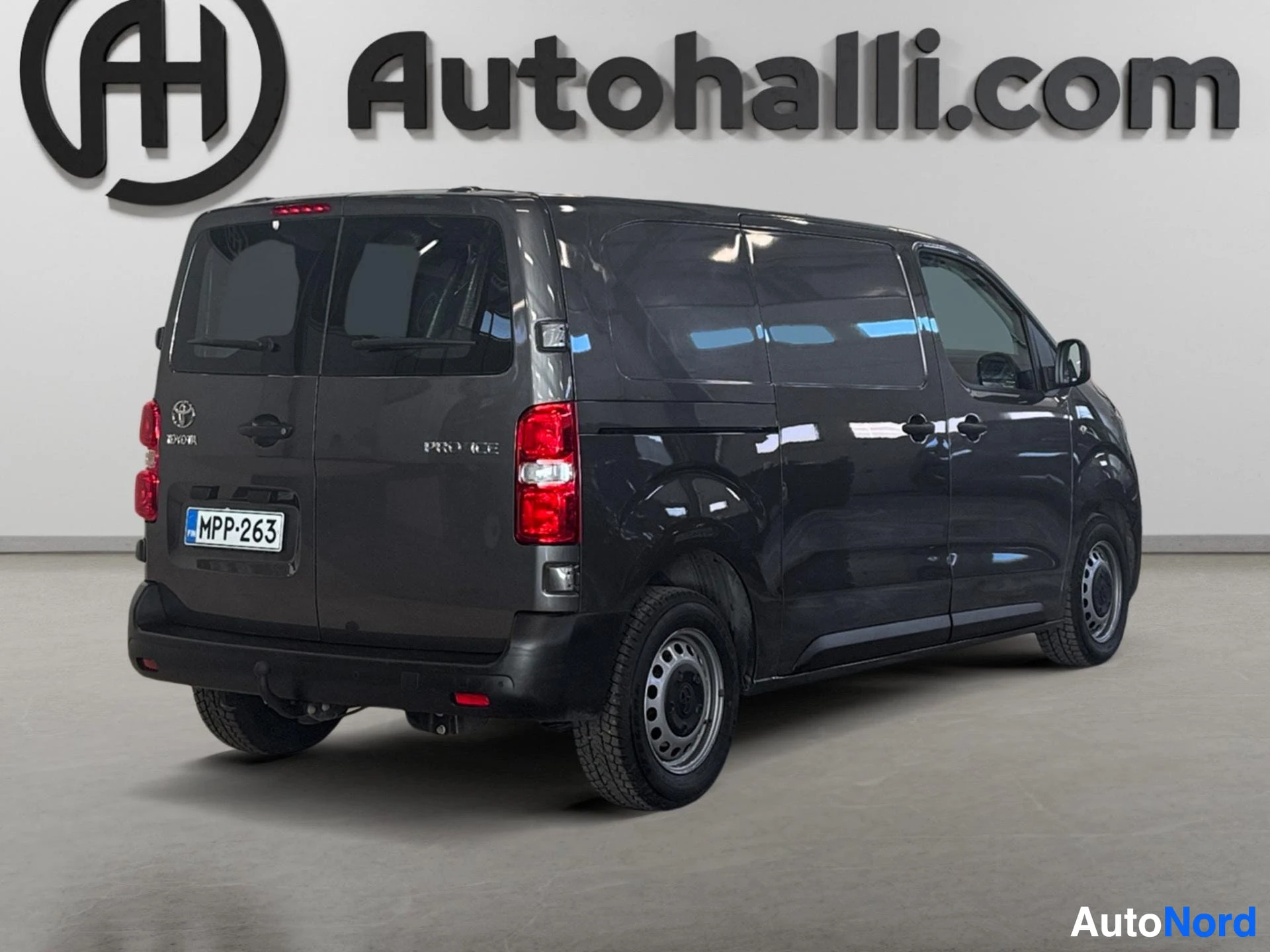 Dark gray Toyota Proace van rear three-quarter view showing taillights and registration plate