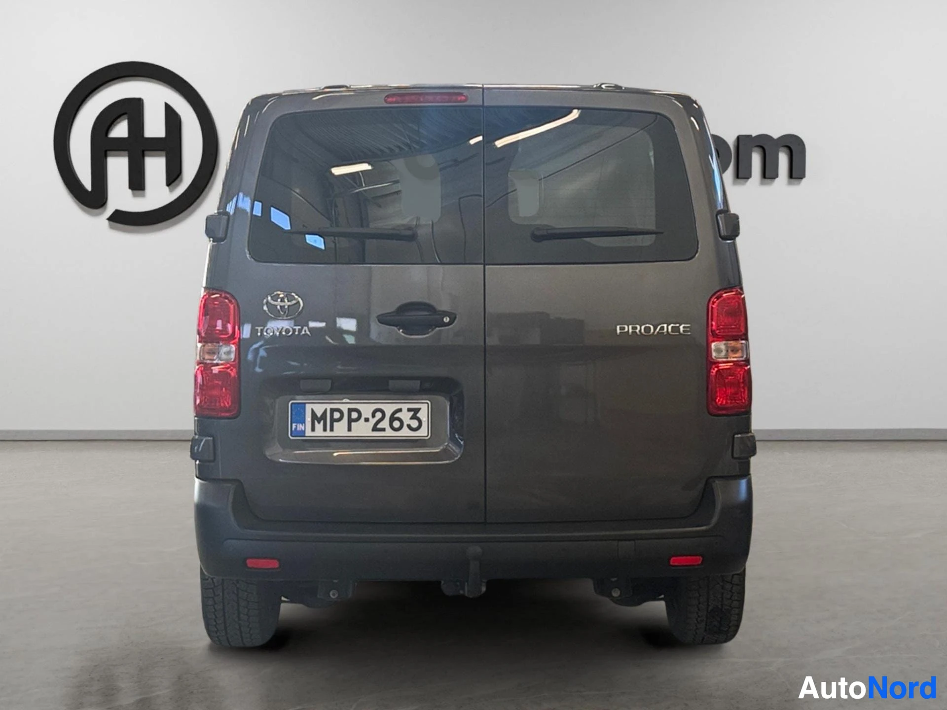 Dark gray Toyota Proace van rear view with taillights and Proace badging visible