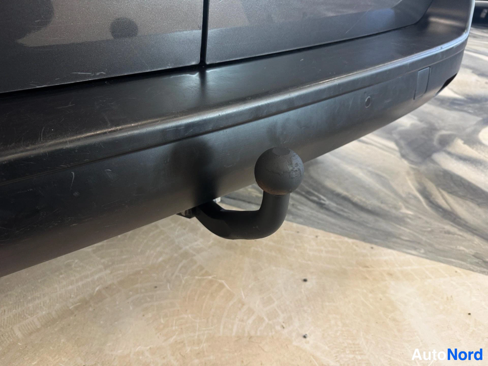 Black towing hitch mounted on vehicle rear bumper
