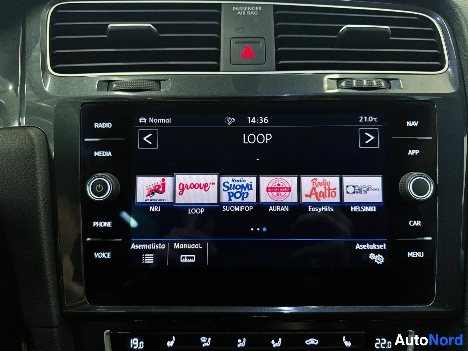 Dashboard touchscreen display showing radio and media interface