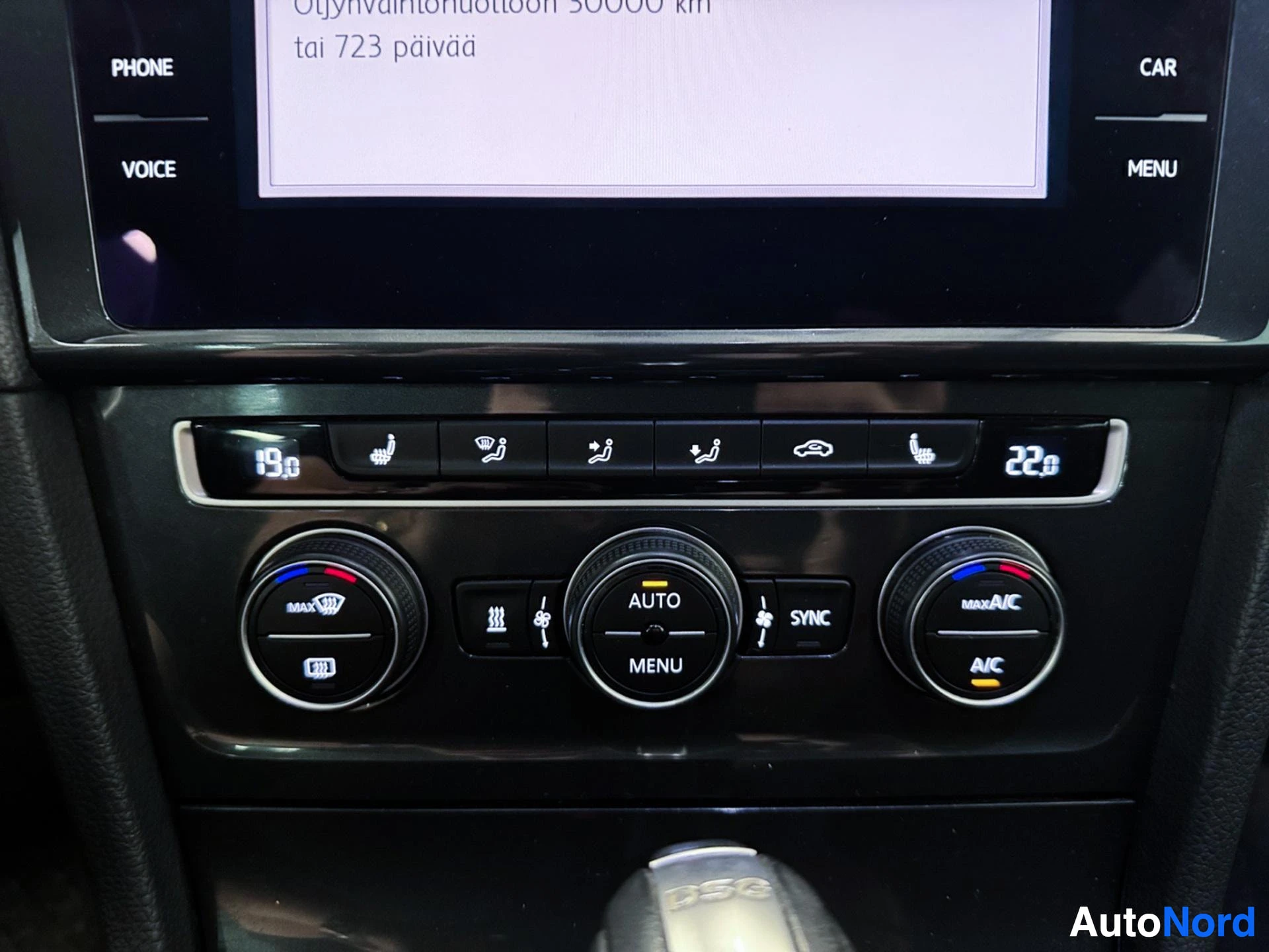 Climate control knobs and dashboard buttons below touchscreen display