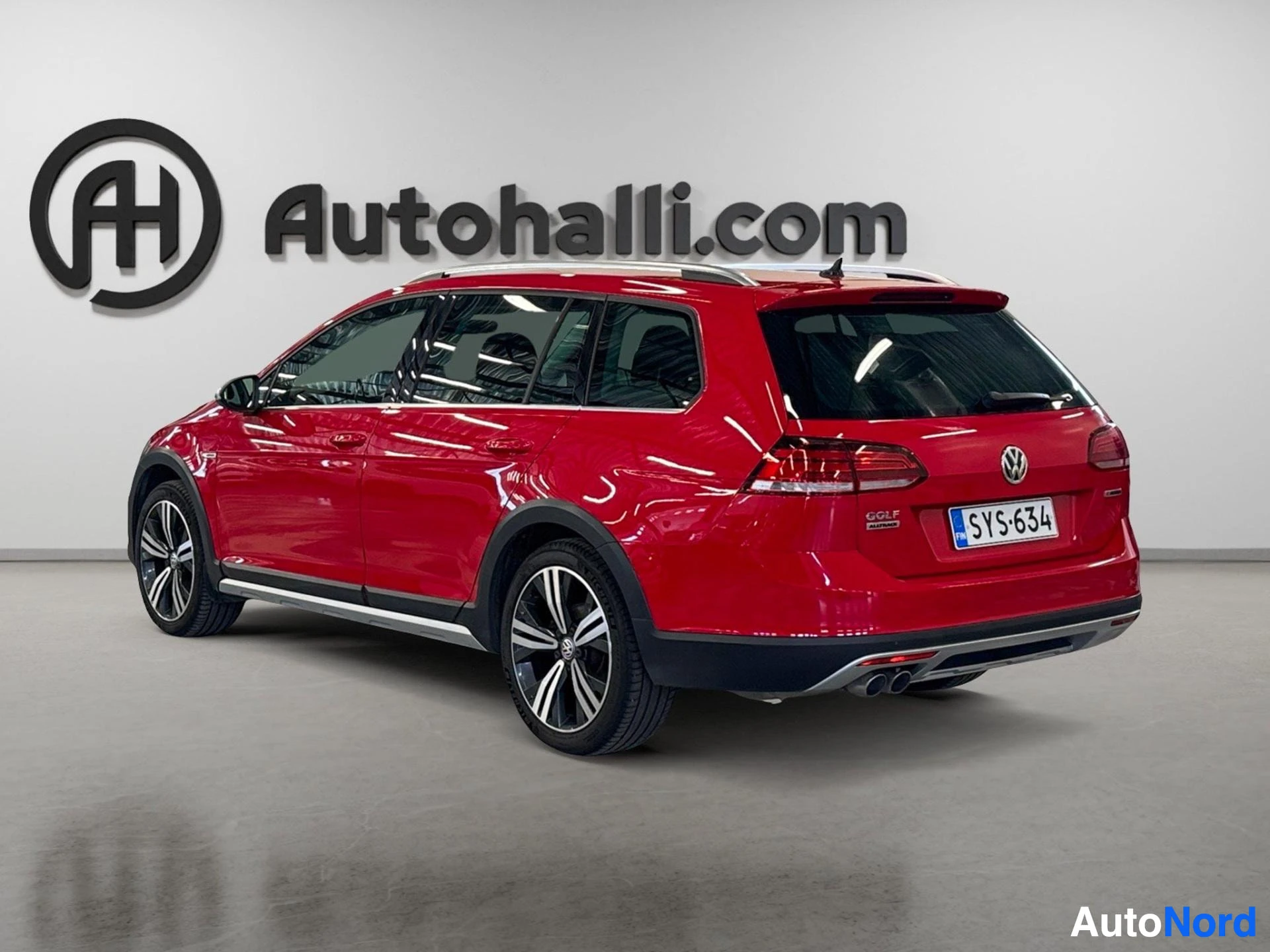 Red Volkswagen wagon rear three-quarter angle with dual exhaust pipes