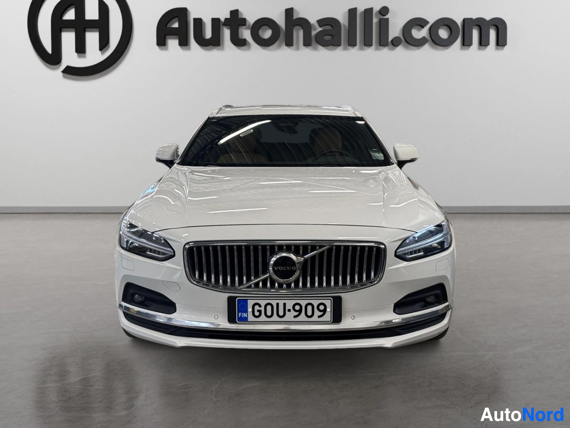 White Volvo V90 front view showing grille and headlights