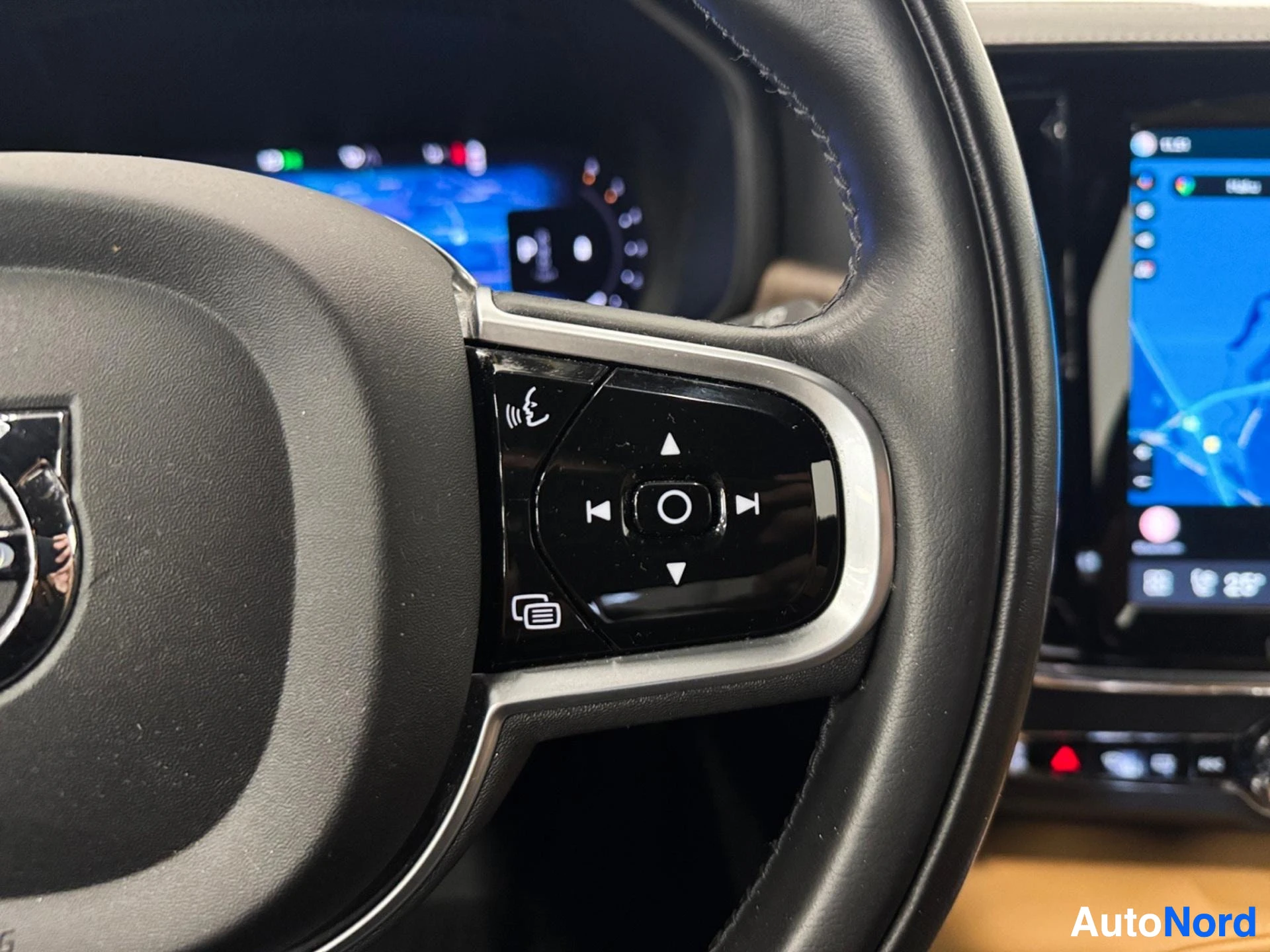 Left steering wheel controls with music and communication buttons visible