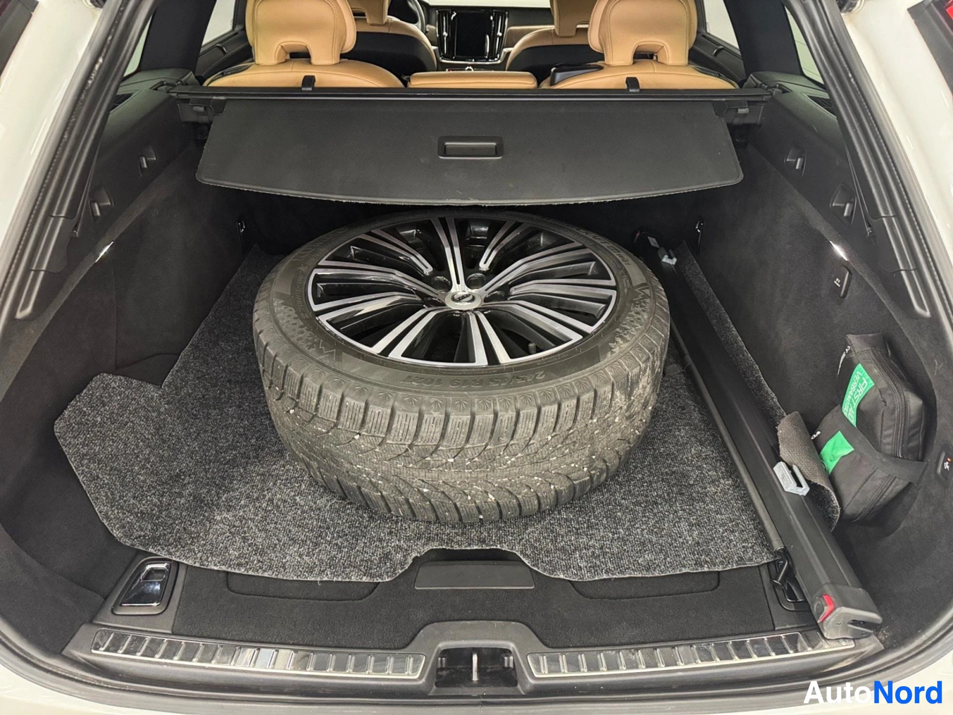 Open cargo trunk showing spare wheel and black interior space