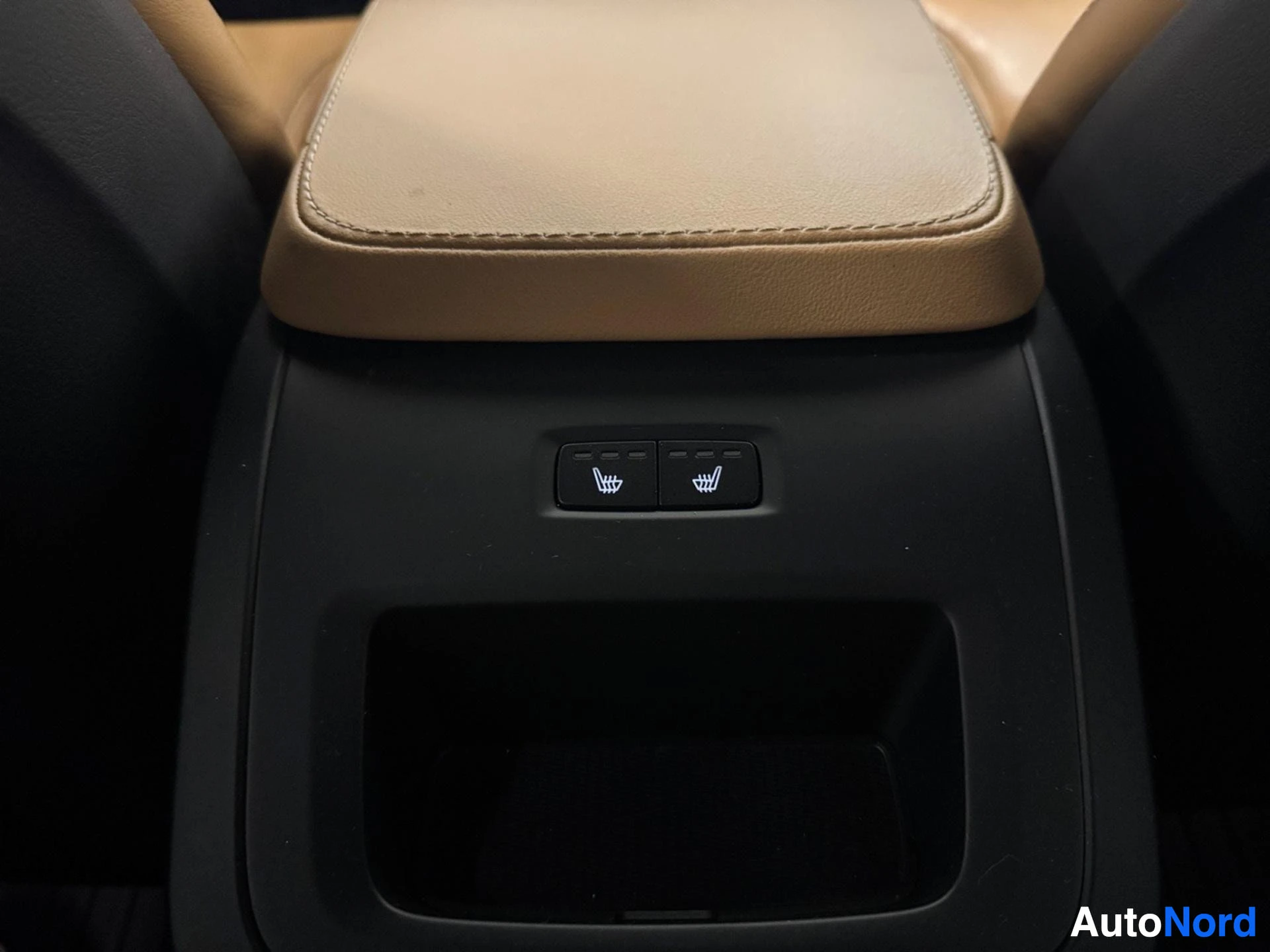 Heated seat control buttons on center armrest