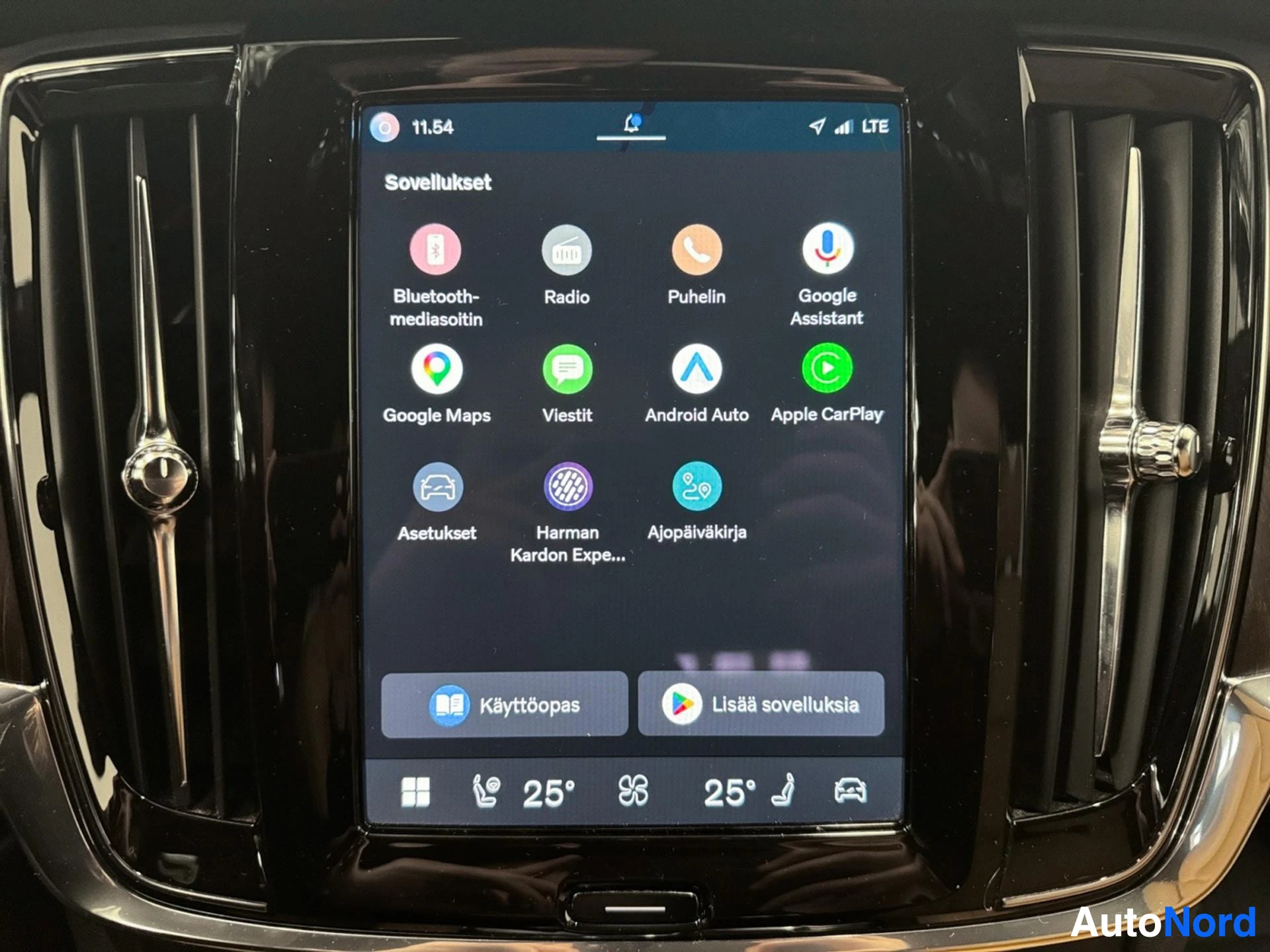 Touchscreen display showing vehicle applications menu and climate controls.