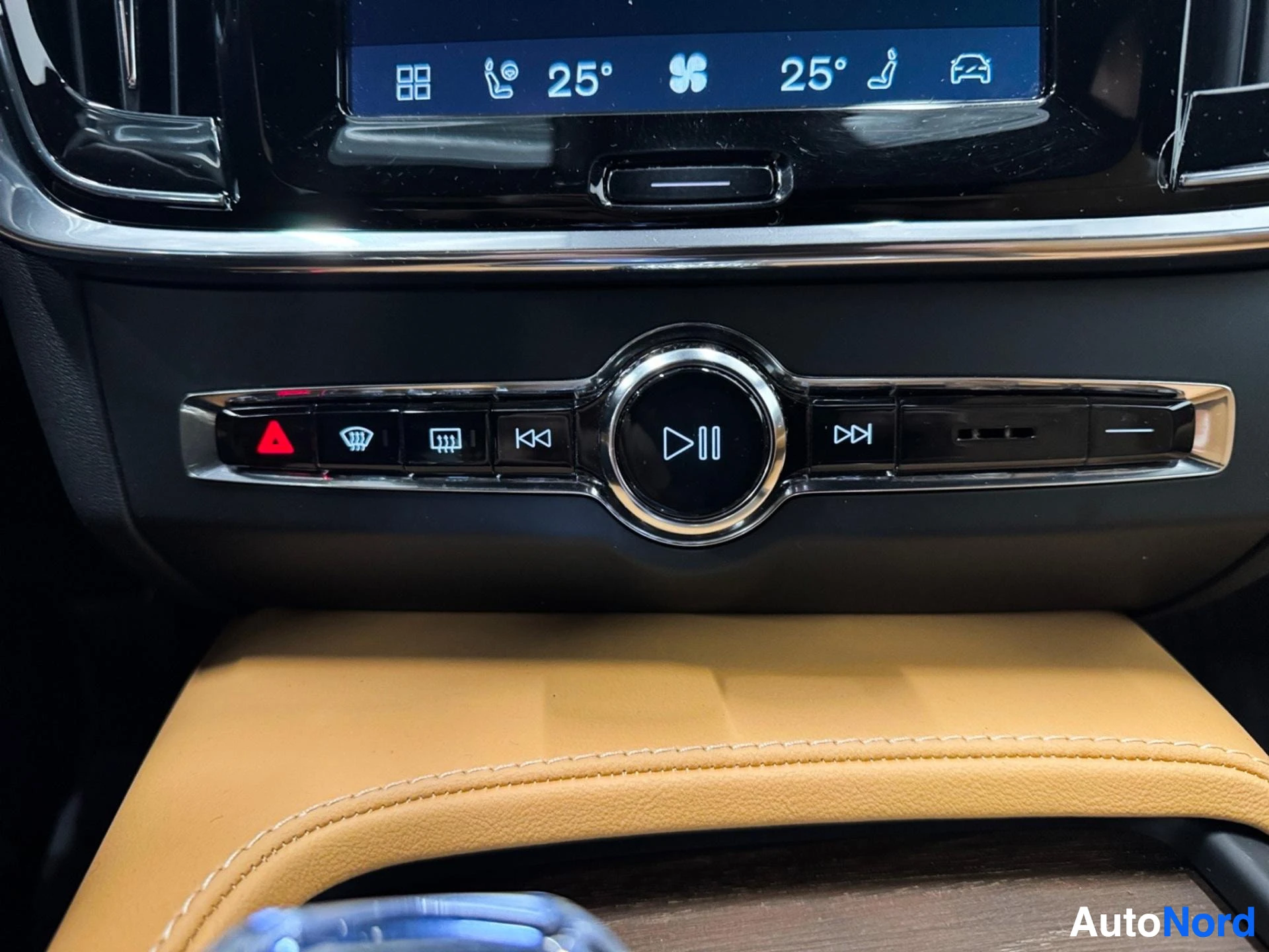 Media control panel with buttons and circular play button below touchscreen.