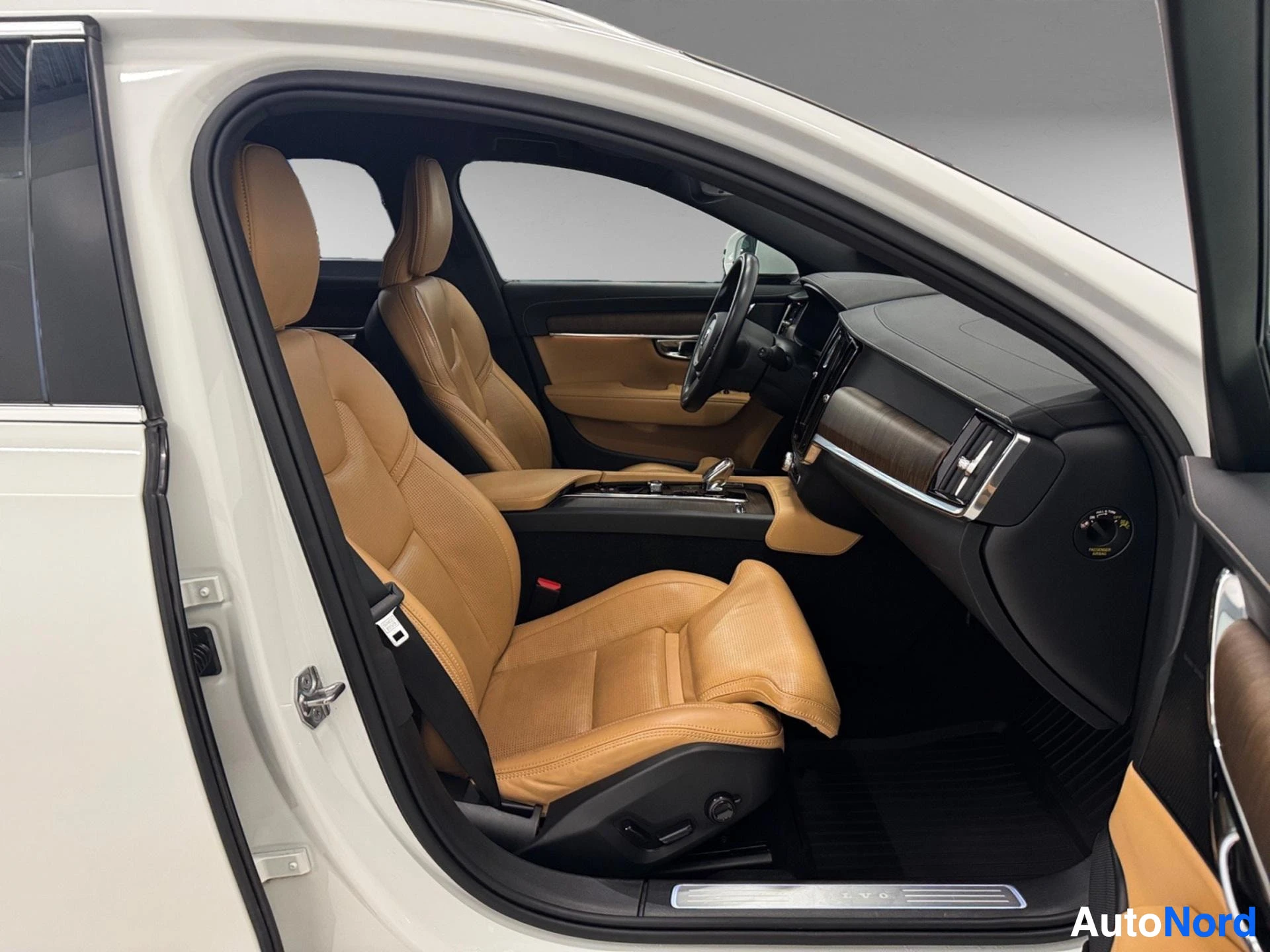 Interior cabin view with tan leather seats and dark dashboard