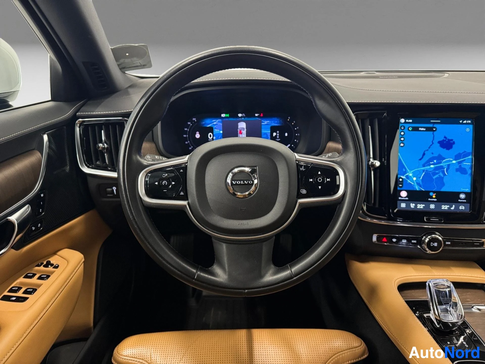 Driver's cockpit with steering wheel, digital display, and touchscreen infotainment