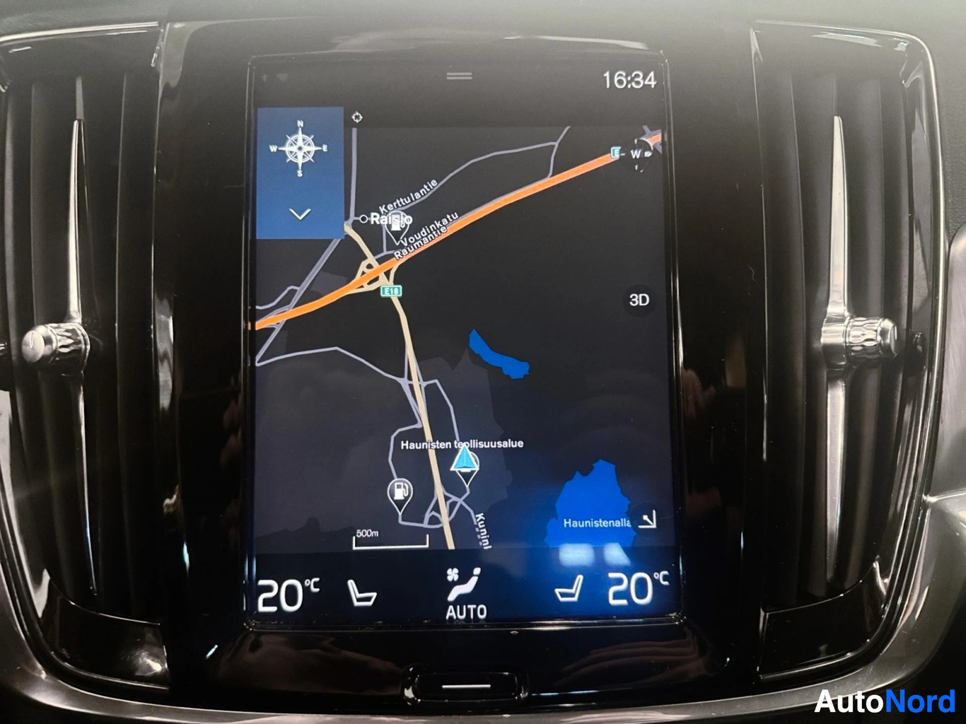 Infotainment screen showing navigation map with route and compass display