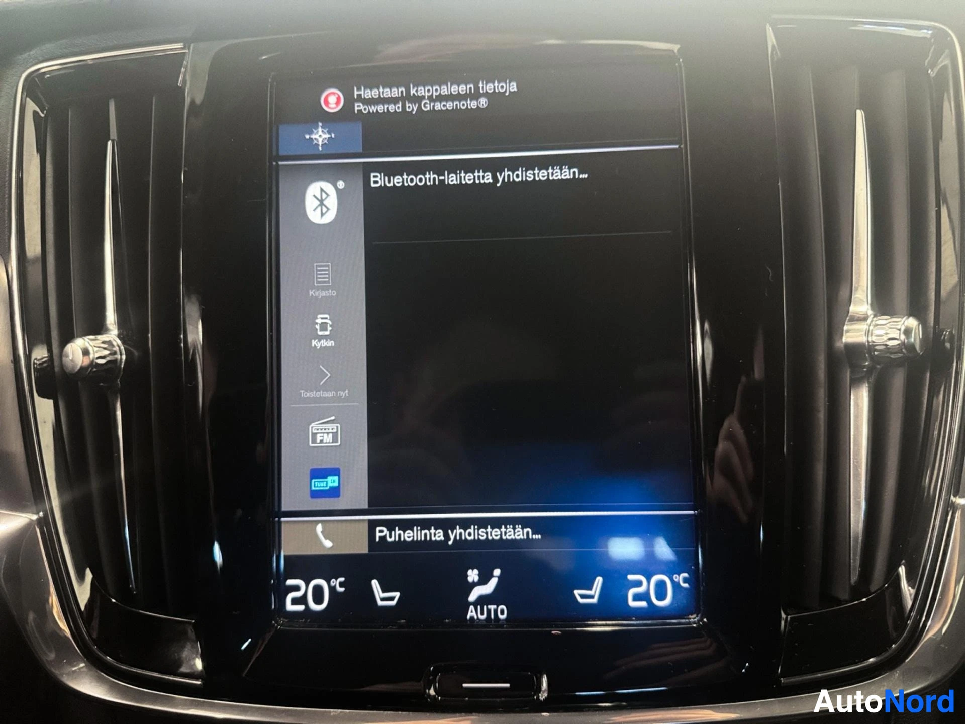 Infotainment display showing Bluetooth connectivity and climate control settings.