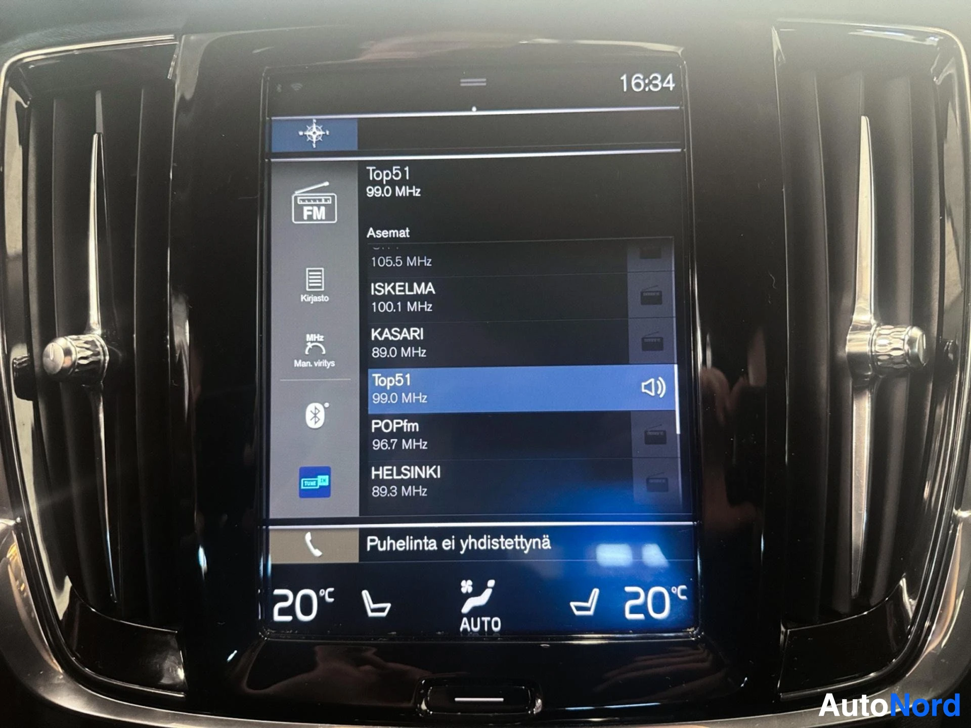 Radio tuner menu on center display showing FM stations and frequencies