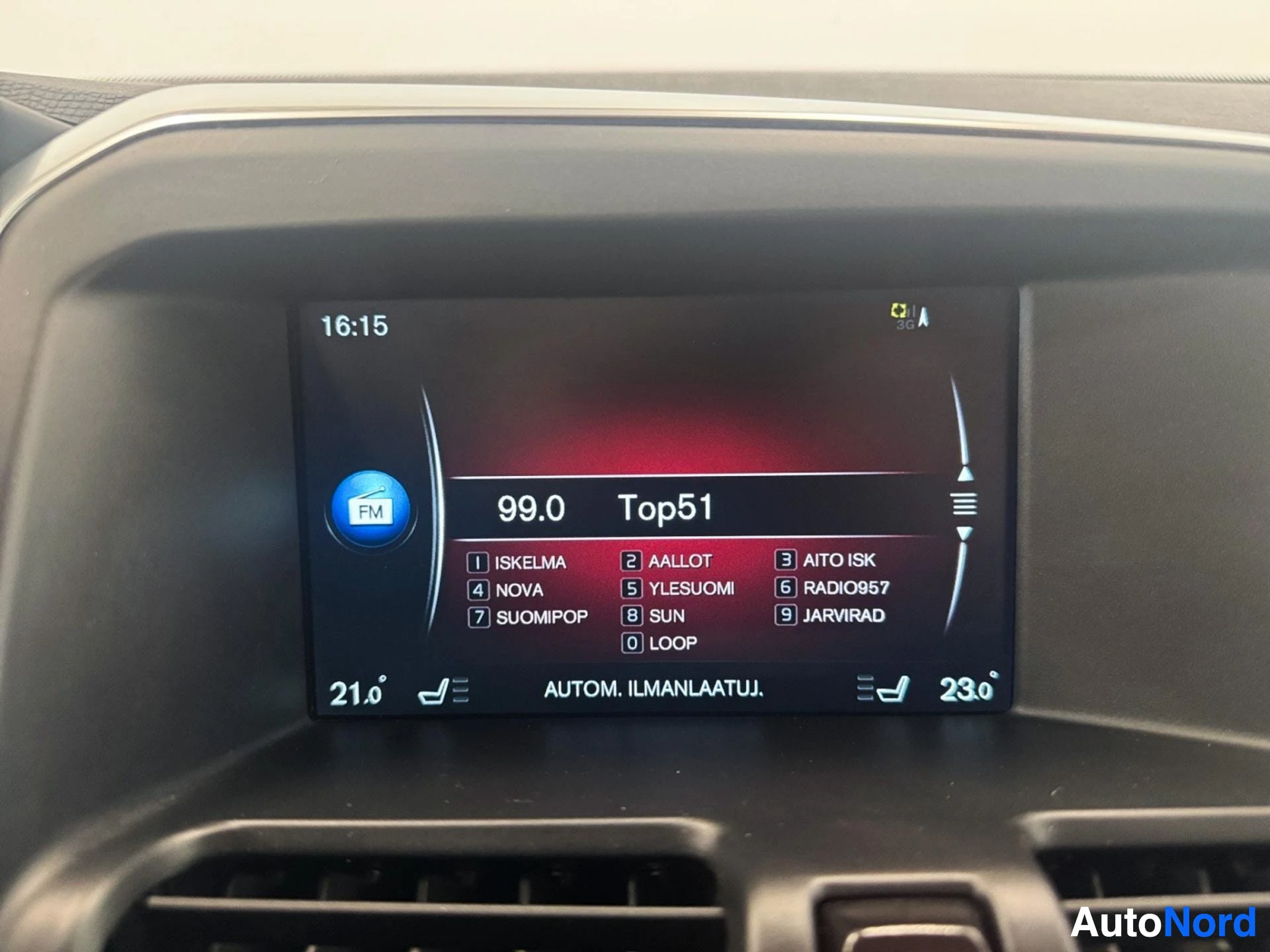 Center infotainment display showing radio with FM tuner and climate controls