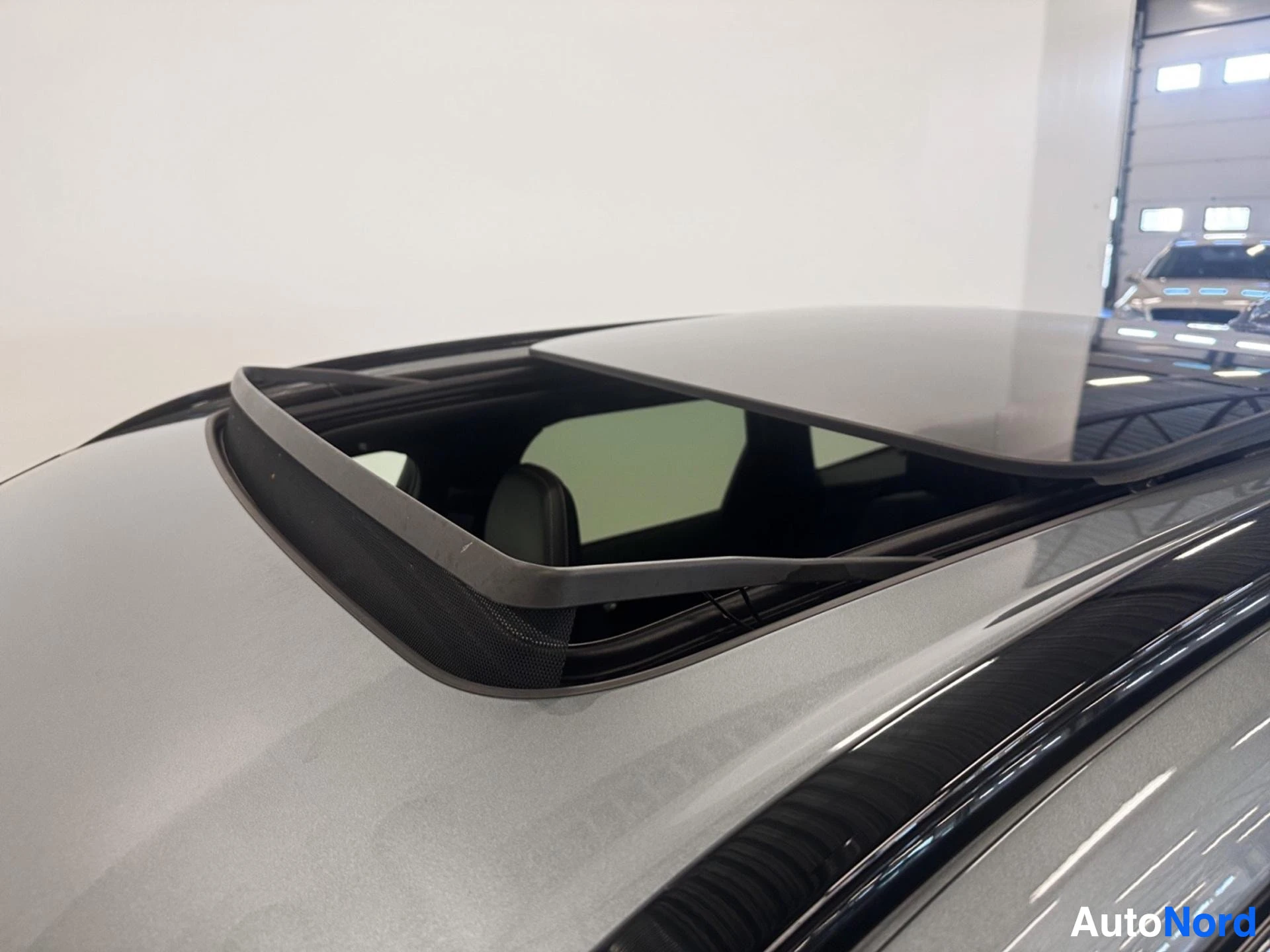Panoramic sunroof open with tinted glass and black trim frame