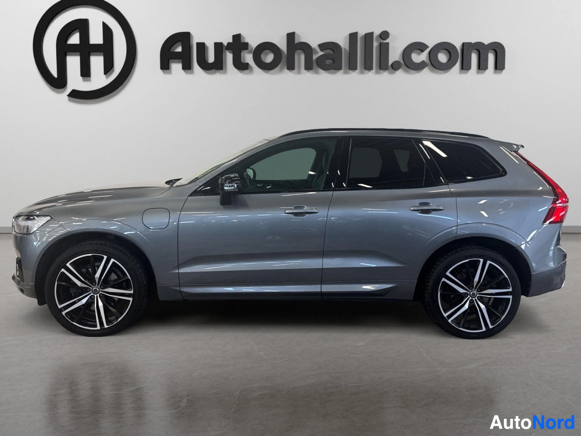 Volvo XC60 hybrid SUV in blue-grey, side profile view from left
