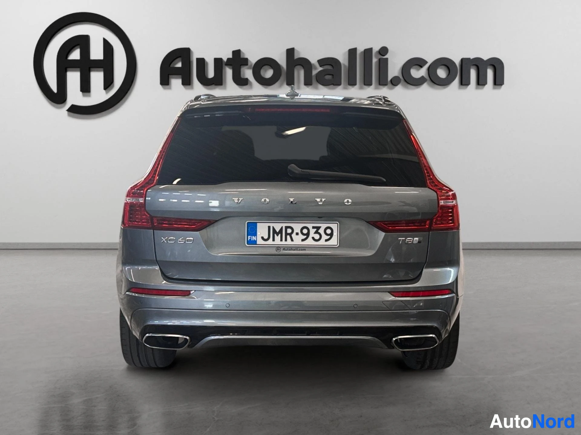 Volvo XC60 hybrid rear view showing tail lights and dual exhaust pipes