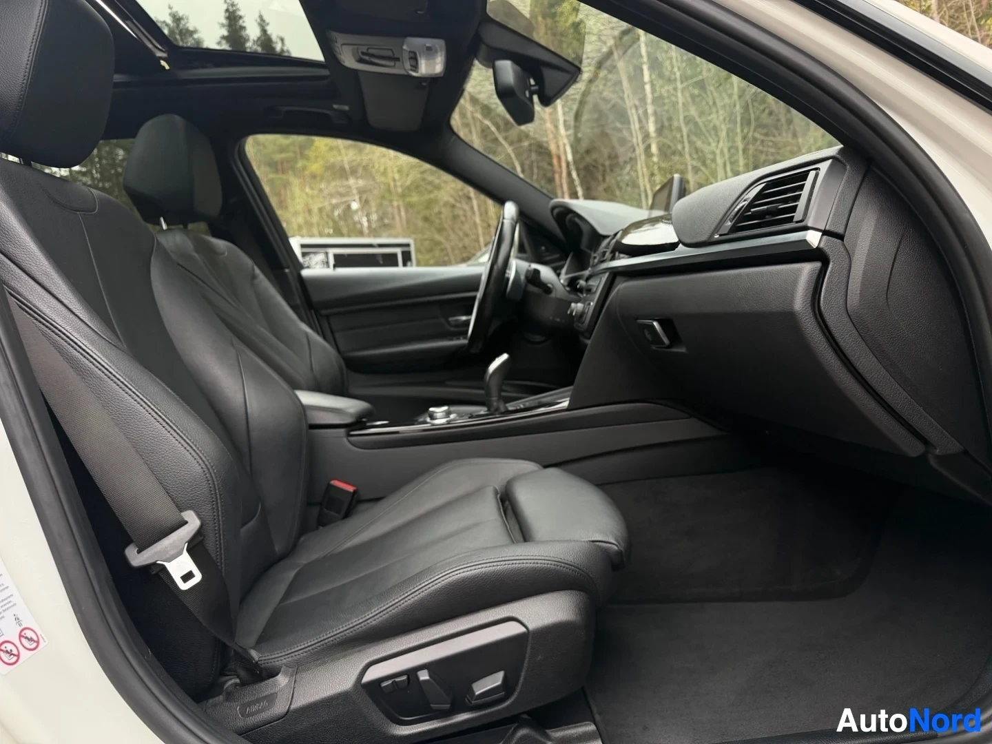Interior cabin showing black leather seats and dashboard from passenger side