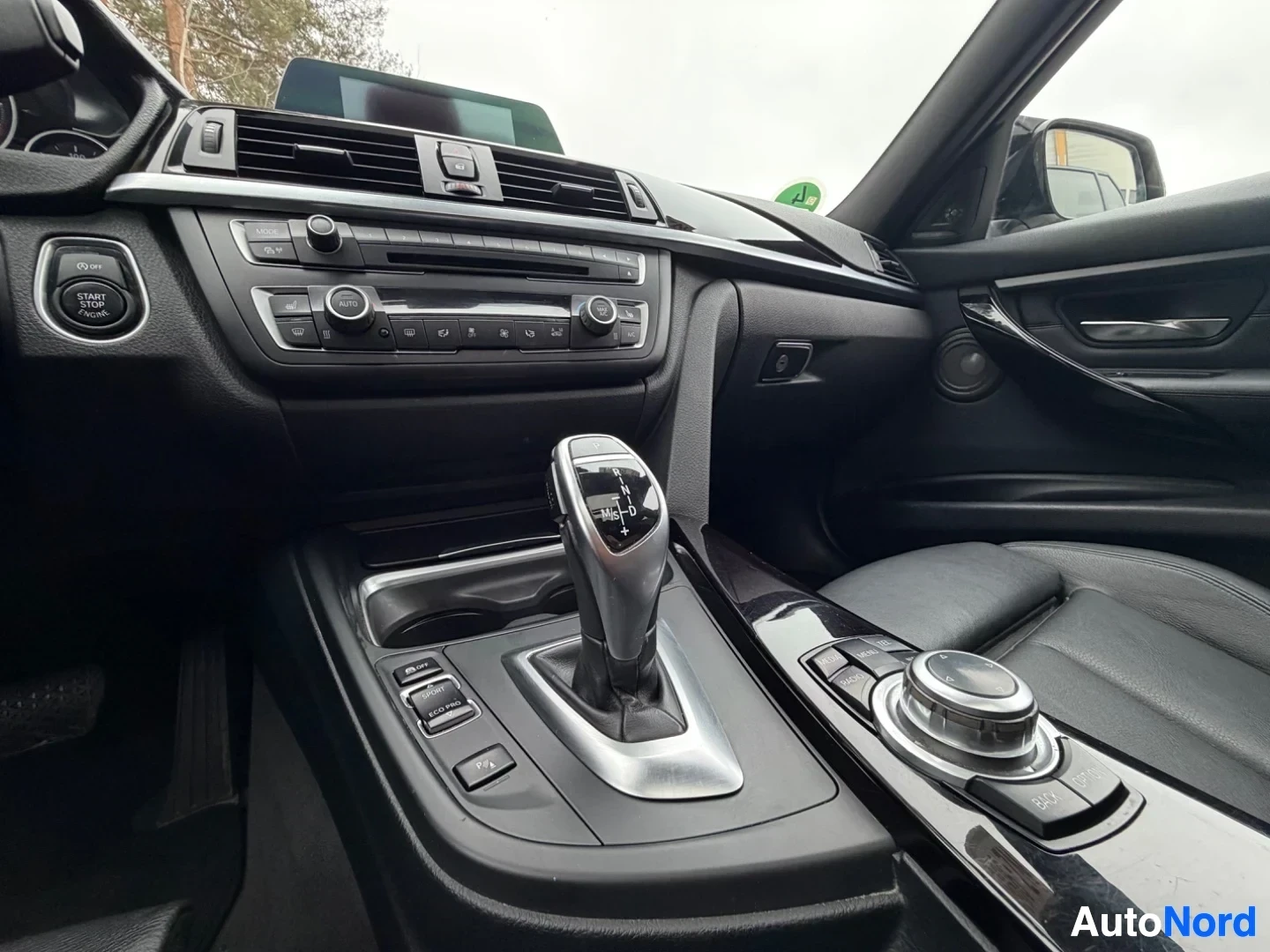 Dashboard with center console, gear shift, climate controls, and steering wheel.