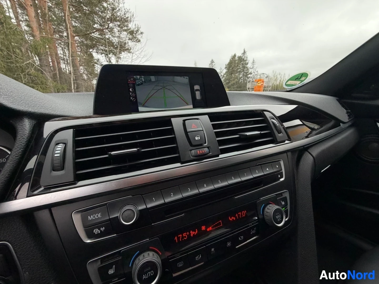 Dashboard display screen with reversing camera, air vents, and climate control panel.