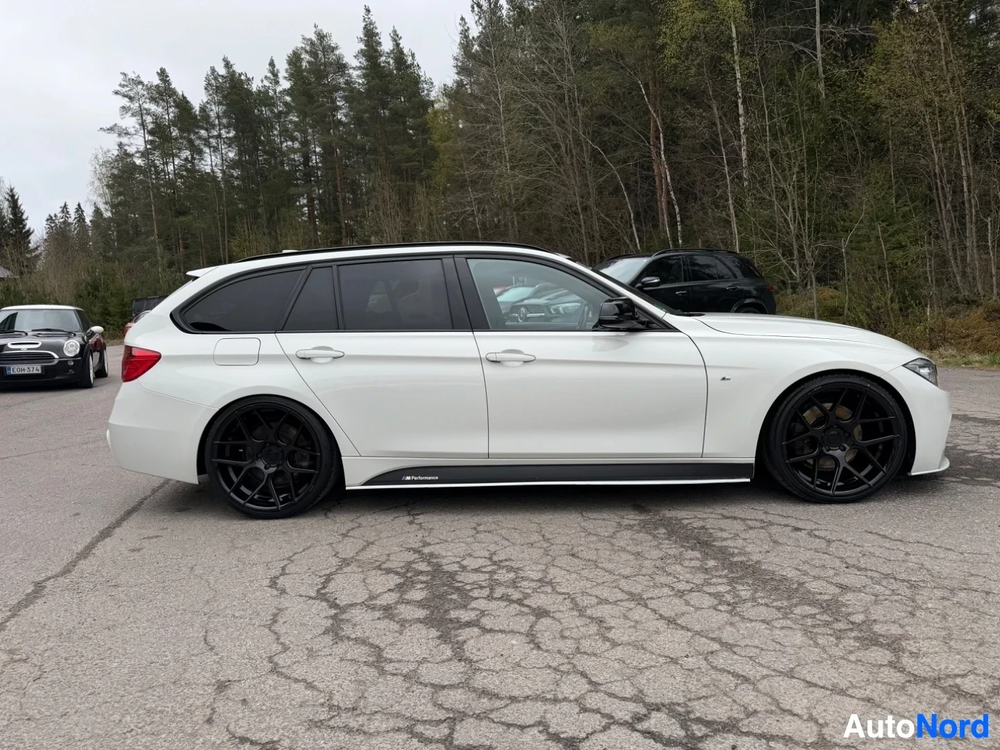 White BMW estate car full side profile view showing entire length of vehicle