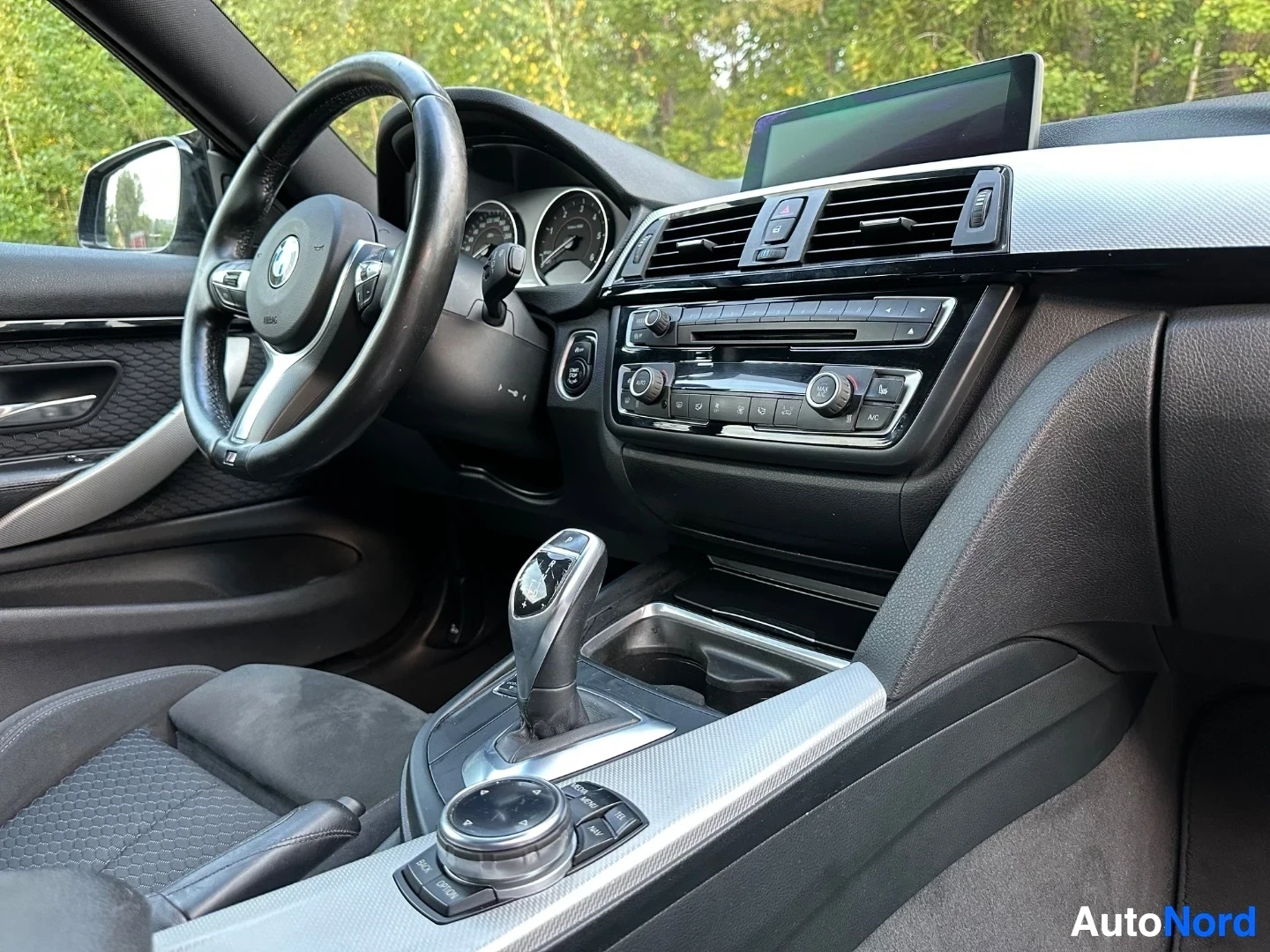 Steering wheel, instrument cluster, center console with gear shifter and climate controls