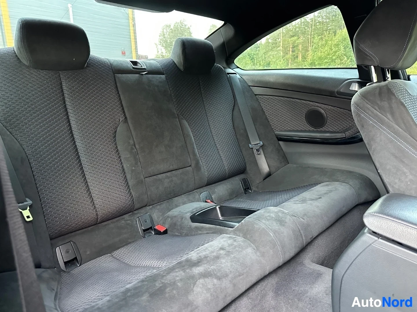 Rear seat interior view with textured upholstery and side windows