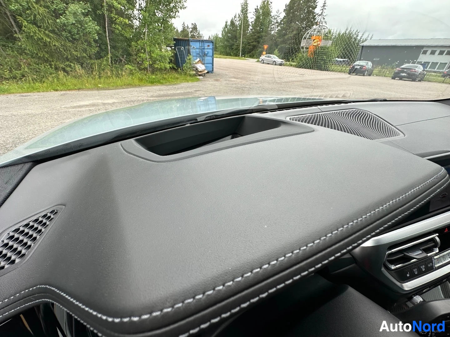 Dashboard and windshield view, leather-trimmed interior with stitching detail