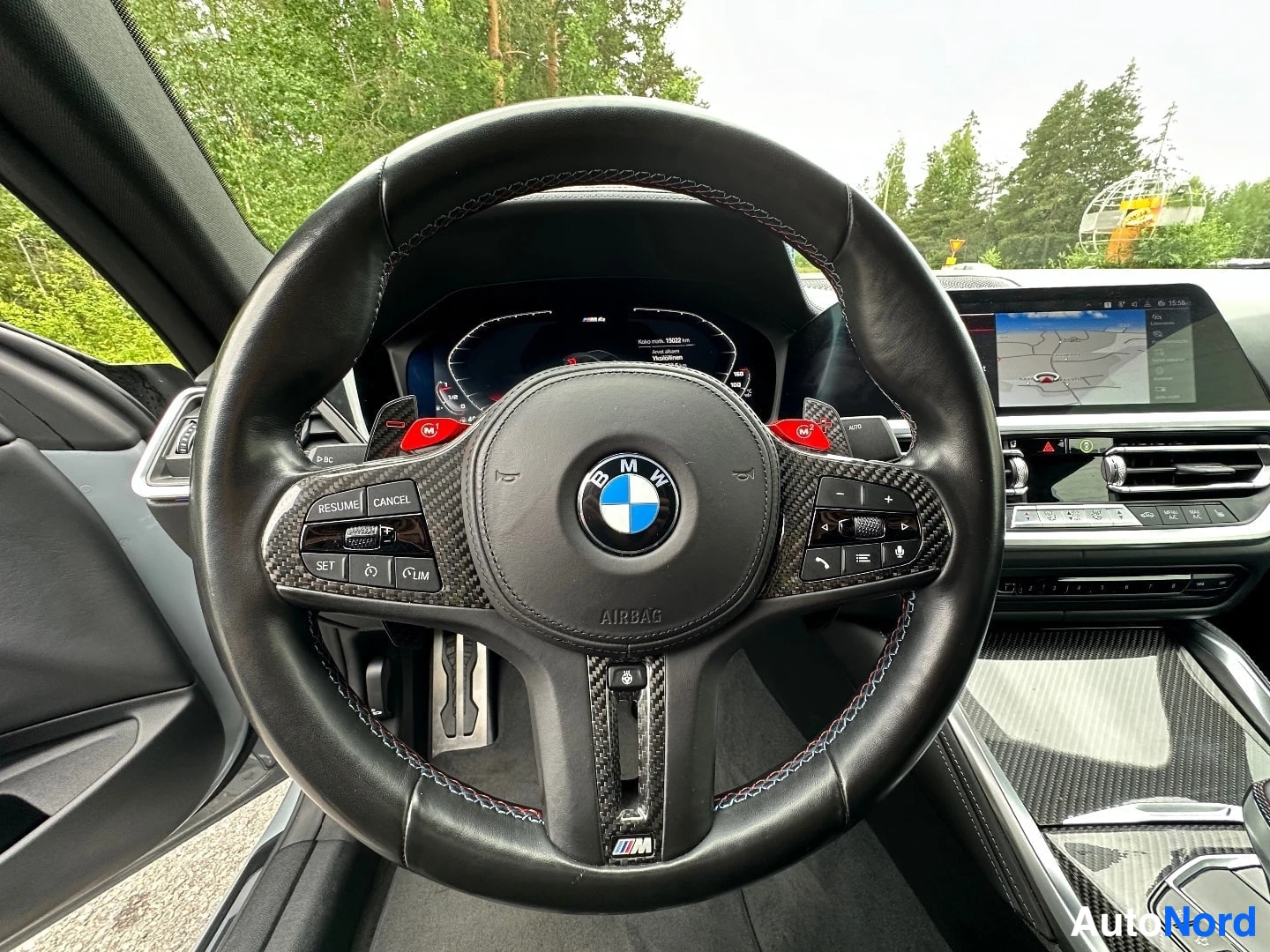 M-Sport steering wheel with red paddle shifters and carbon trim