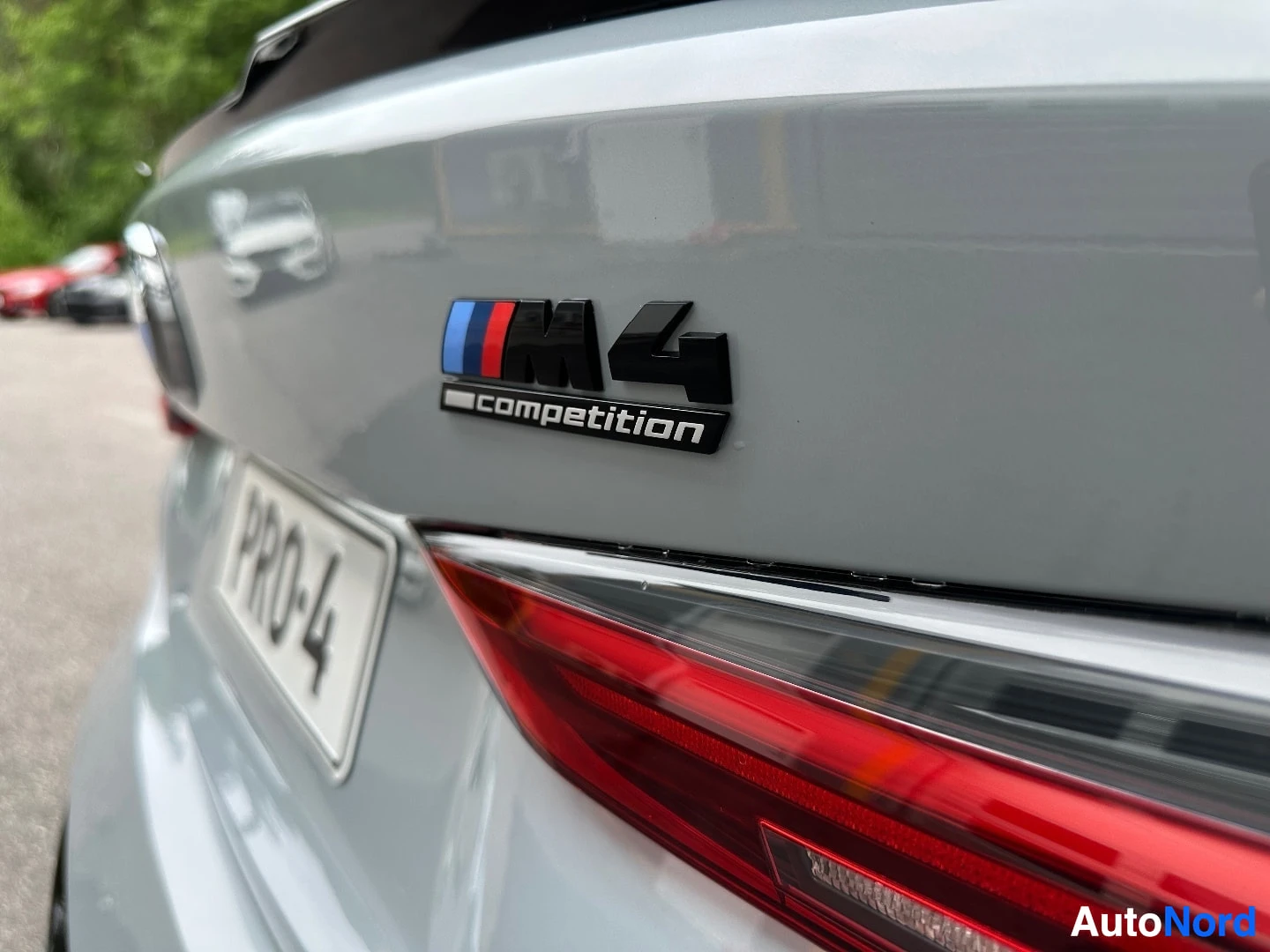 M4 Competition badge and rear light detail on white coupe