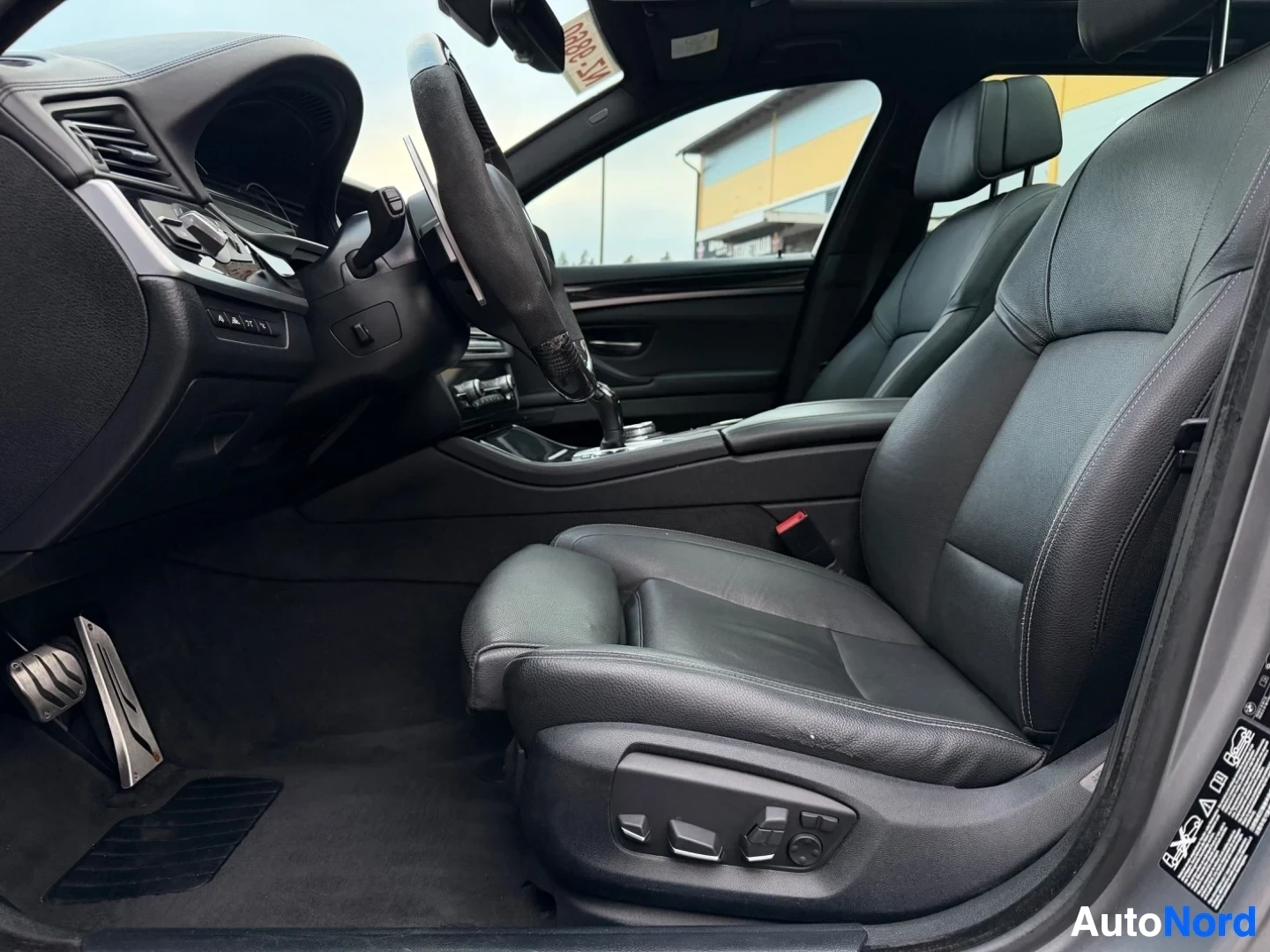 Interior cabin with dark leather seats and steering wheel