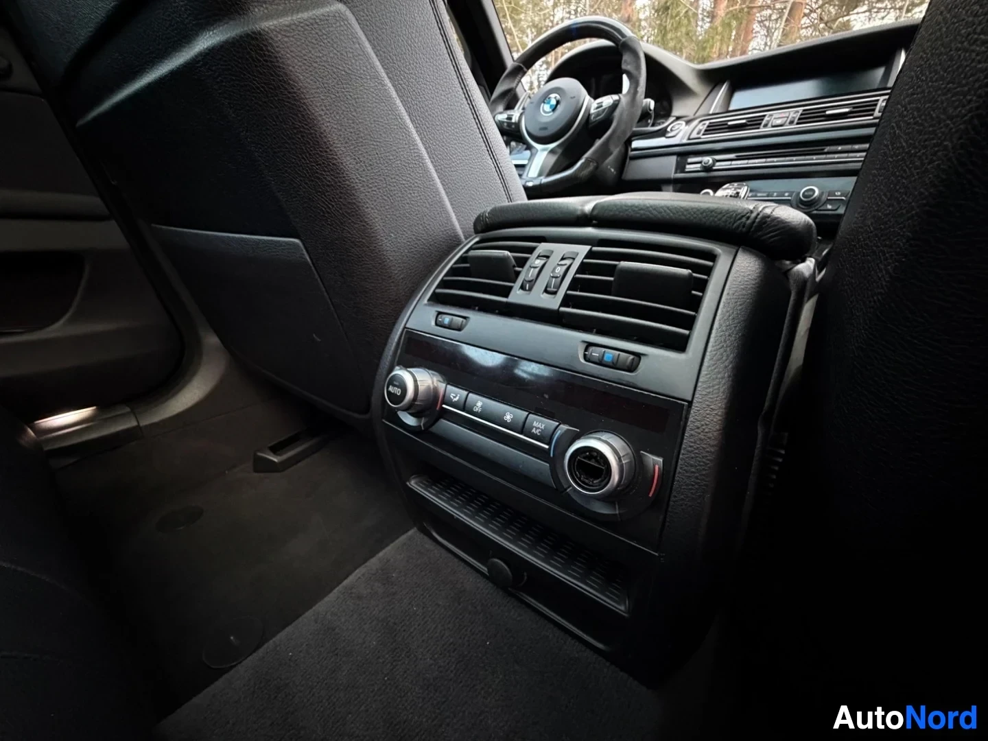 Driver's side dashboard with steering wheel and climate controls visible
