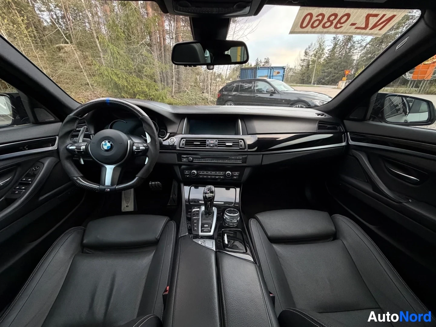 Full dashboard view from driver seat with steering wheel and center console