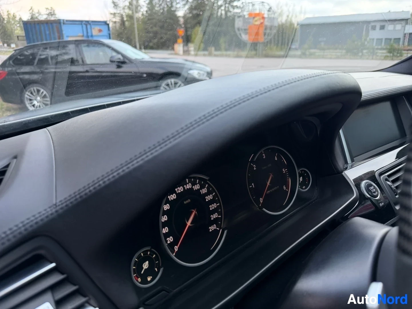 Instrument cluster and gauges visible on dashboard