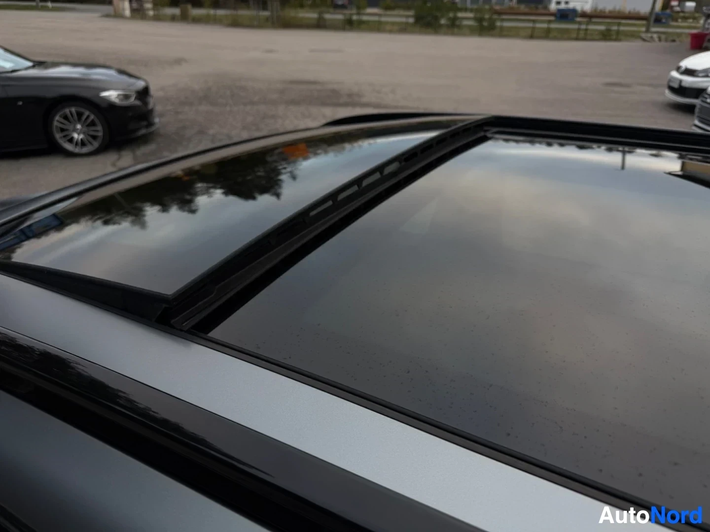 Panoramic sunroof with black frame on car roof