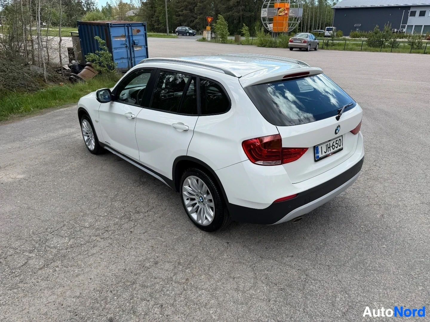 White BMW X1 SUV rear three-quarter view in outdoor lot